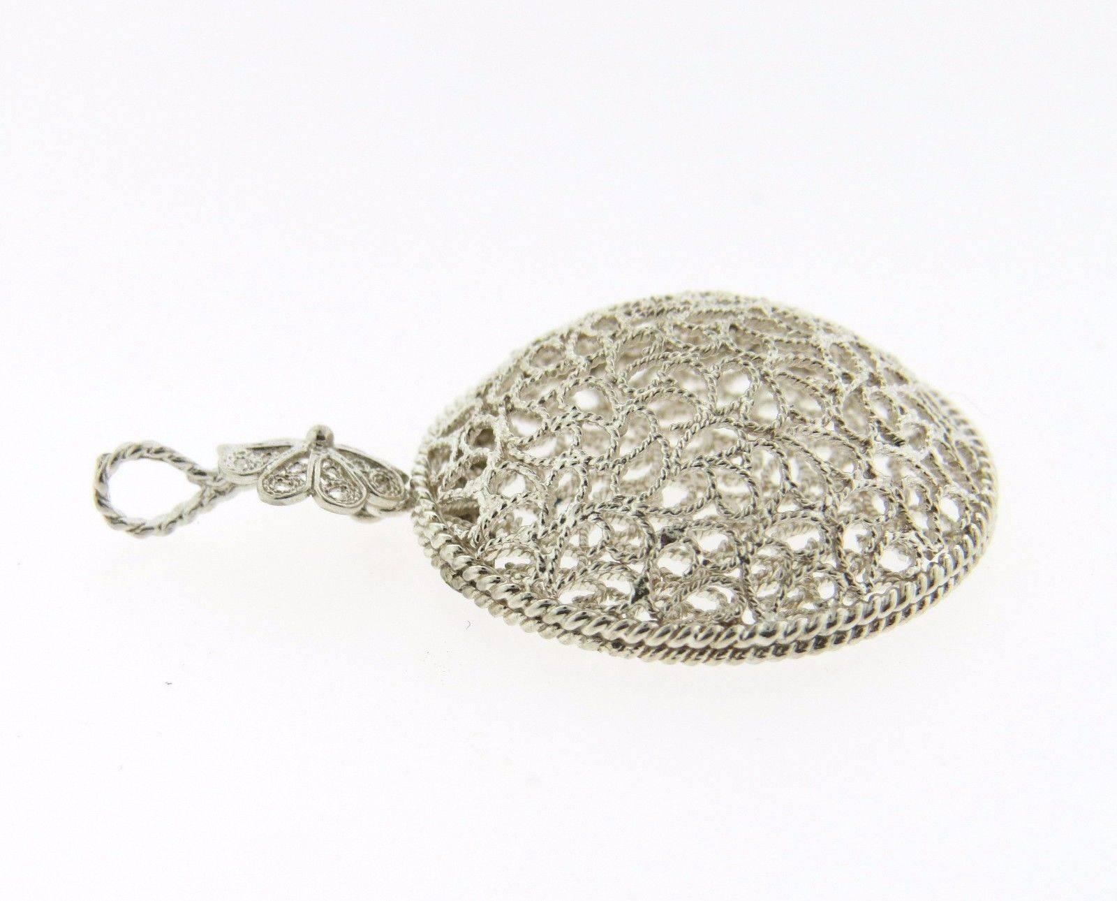 A sterling silver pendant by Buccellati.  The pendant measures 38mm long (including bale) x 25mm.  Marked: Buccellati, 750.  The weight of the pendant is 3.3 grams. Comes with original Buccellati paperwork.