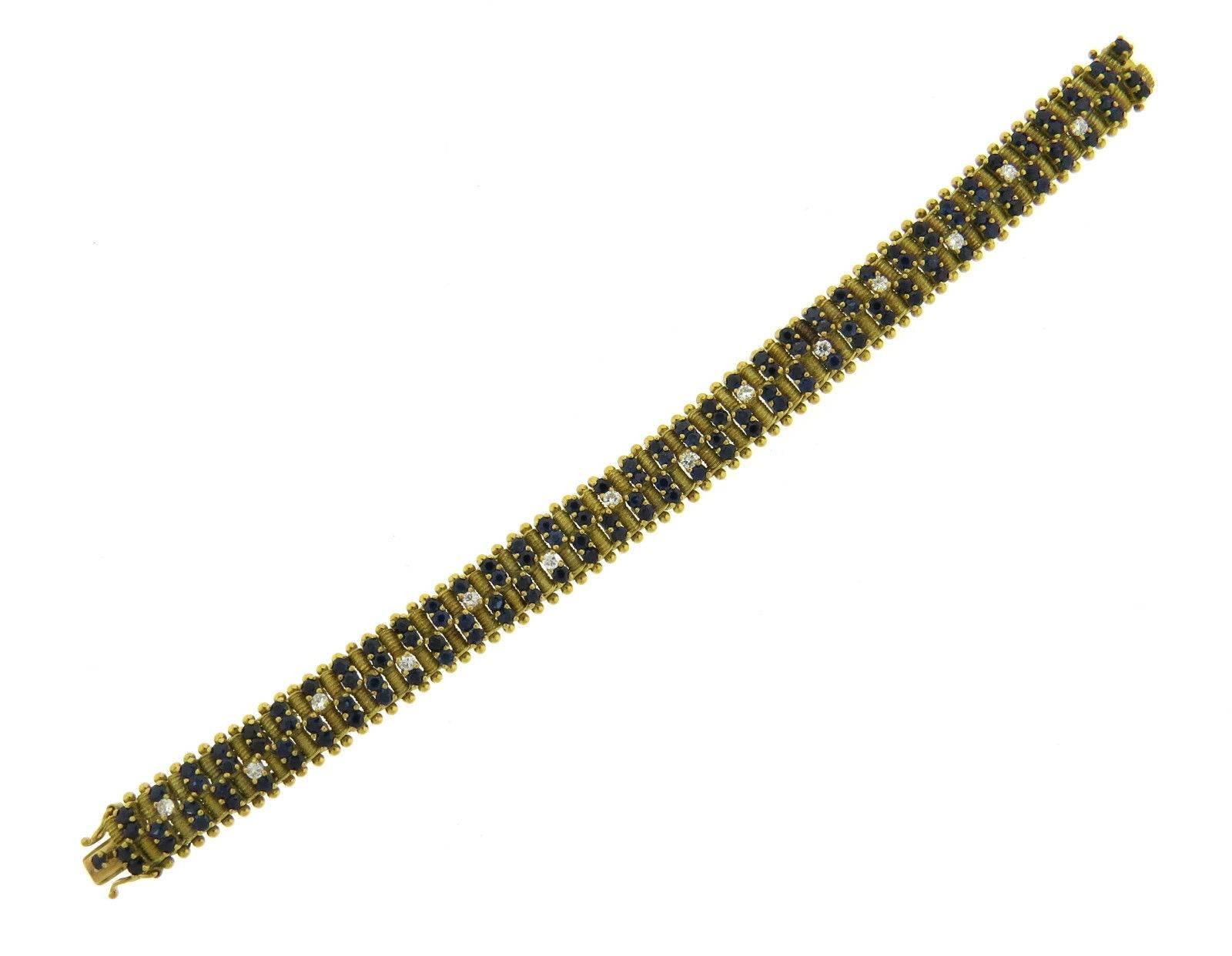 An 18k yellow gold bracelet set sapphires and approximately 0.70ctw of GH/VS diamonds. The bracelet is 7 1/4