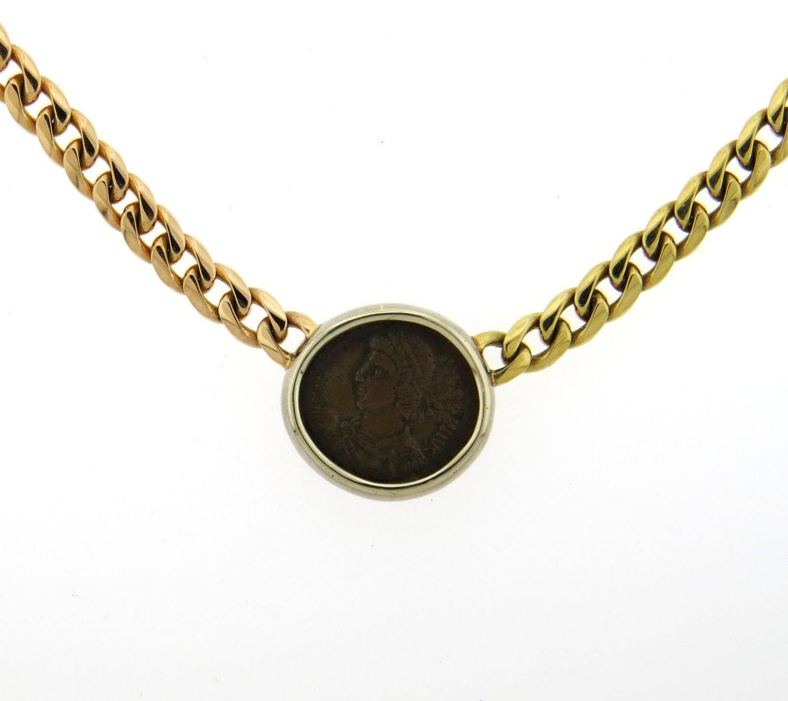 An 18k yellow rose and white gold necklace set with an ancient coin.  The necklace is 16 1/8