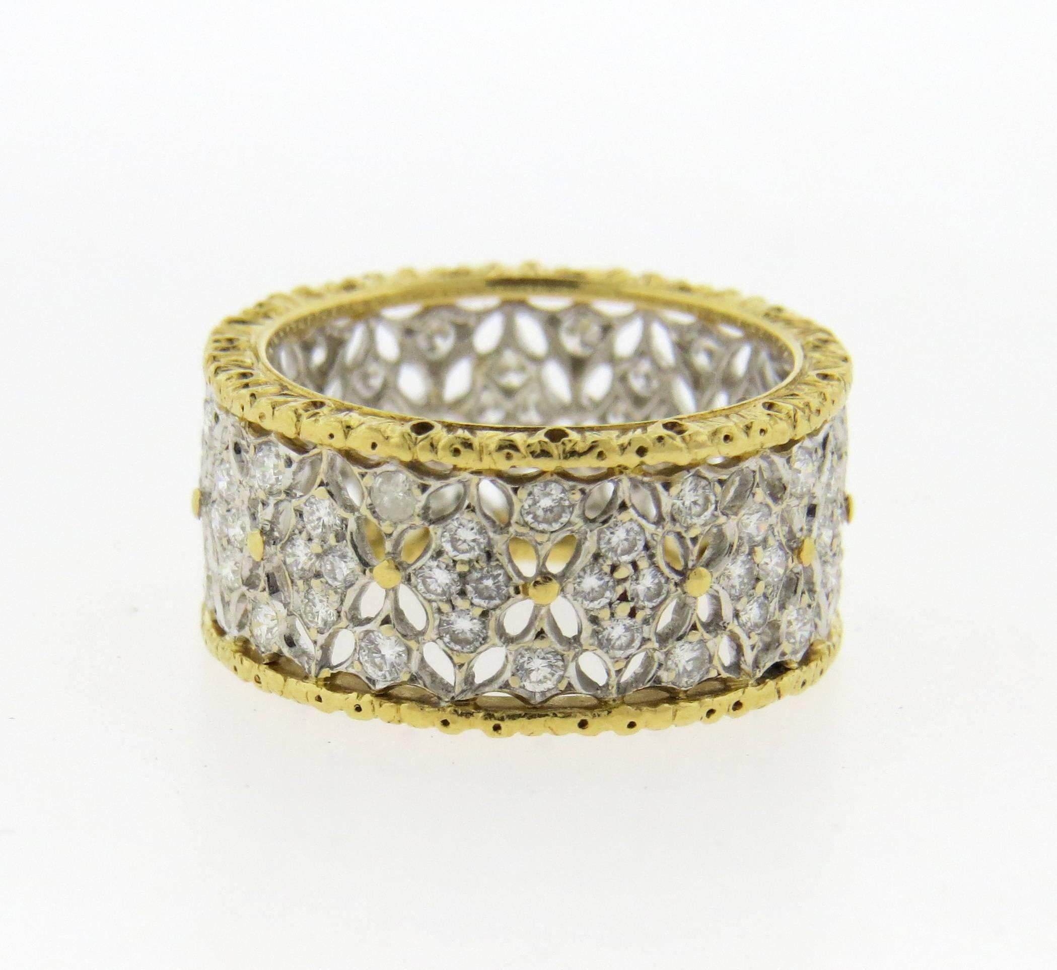 An 18k white and yellow gold band ring set with approximately 0.55ctw of H/VS diamonds.  The ring is a size 6.5 and 8.9mm wide.  The weight of the piece is 5.1 grams.  Marked: Buccellati, Italy, 18k.