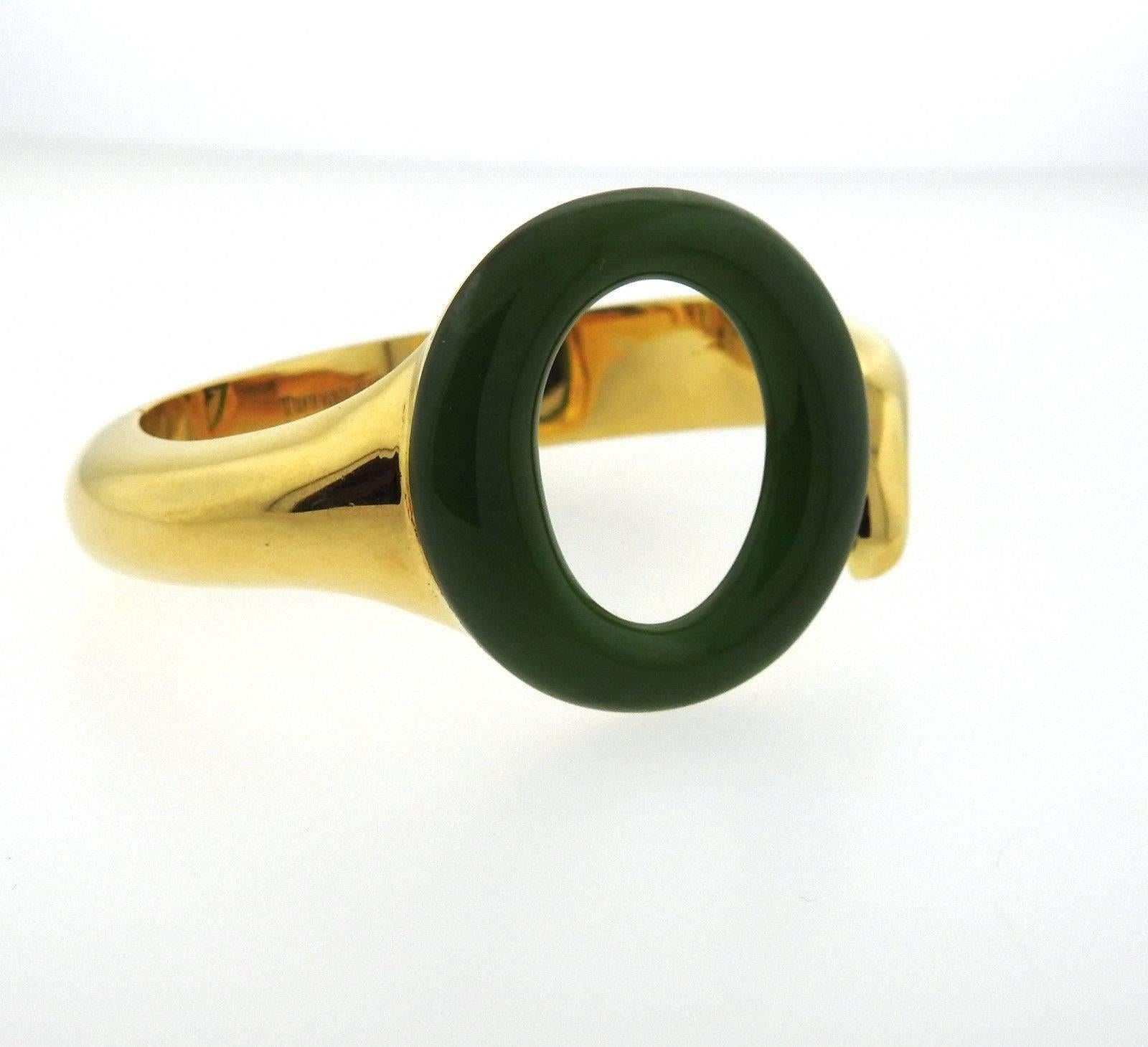 An 18k yellow gold bracelet set with Jade measuring 35mm in diameter.  The bracelet will comfortably fit 6 1/2