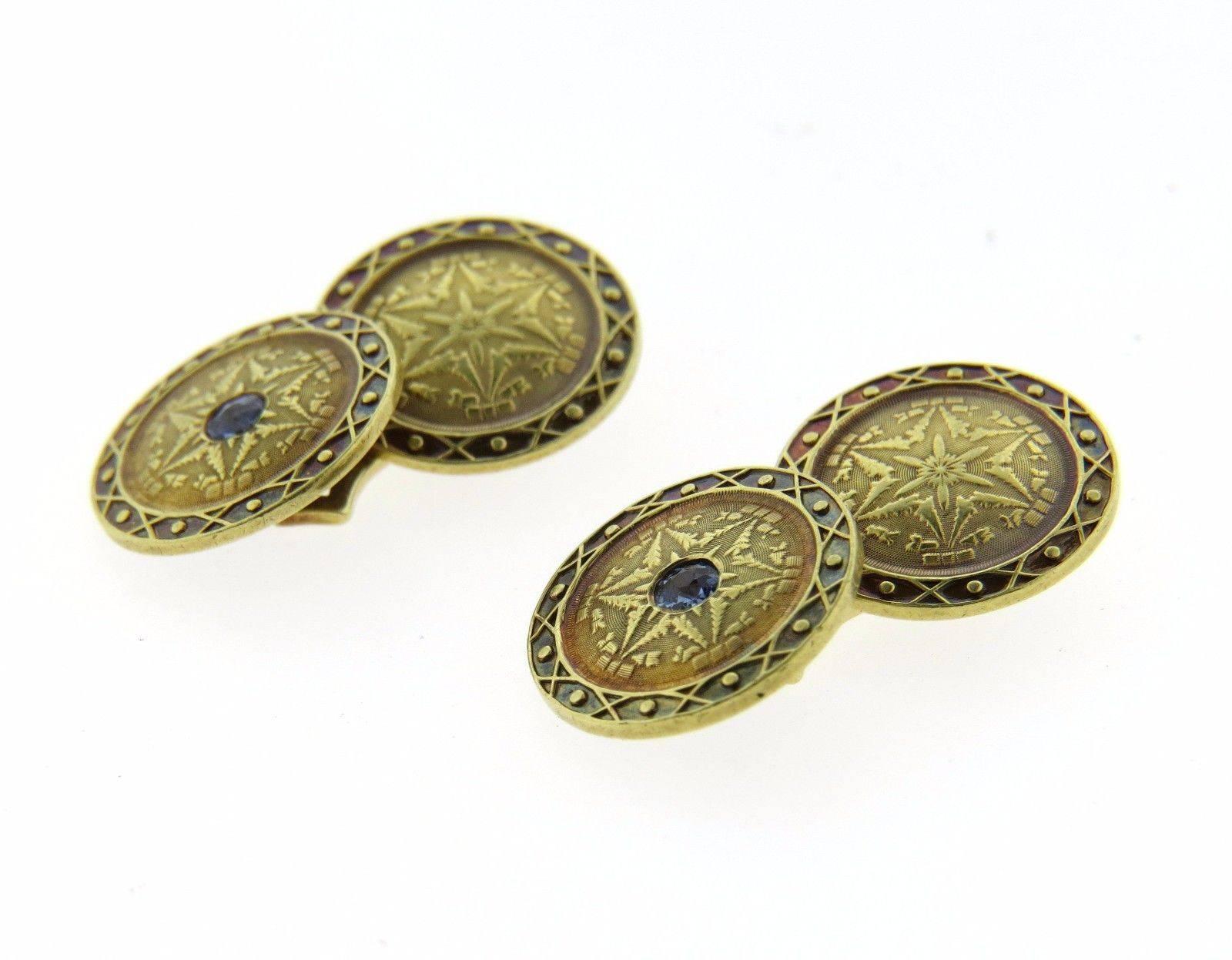 A pair 14k yellow gold cufflinks set with sapphires, measuring 15mm in diameter and weighing 9.3 grams.