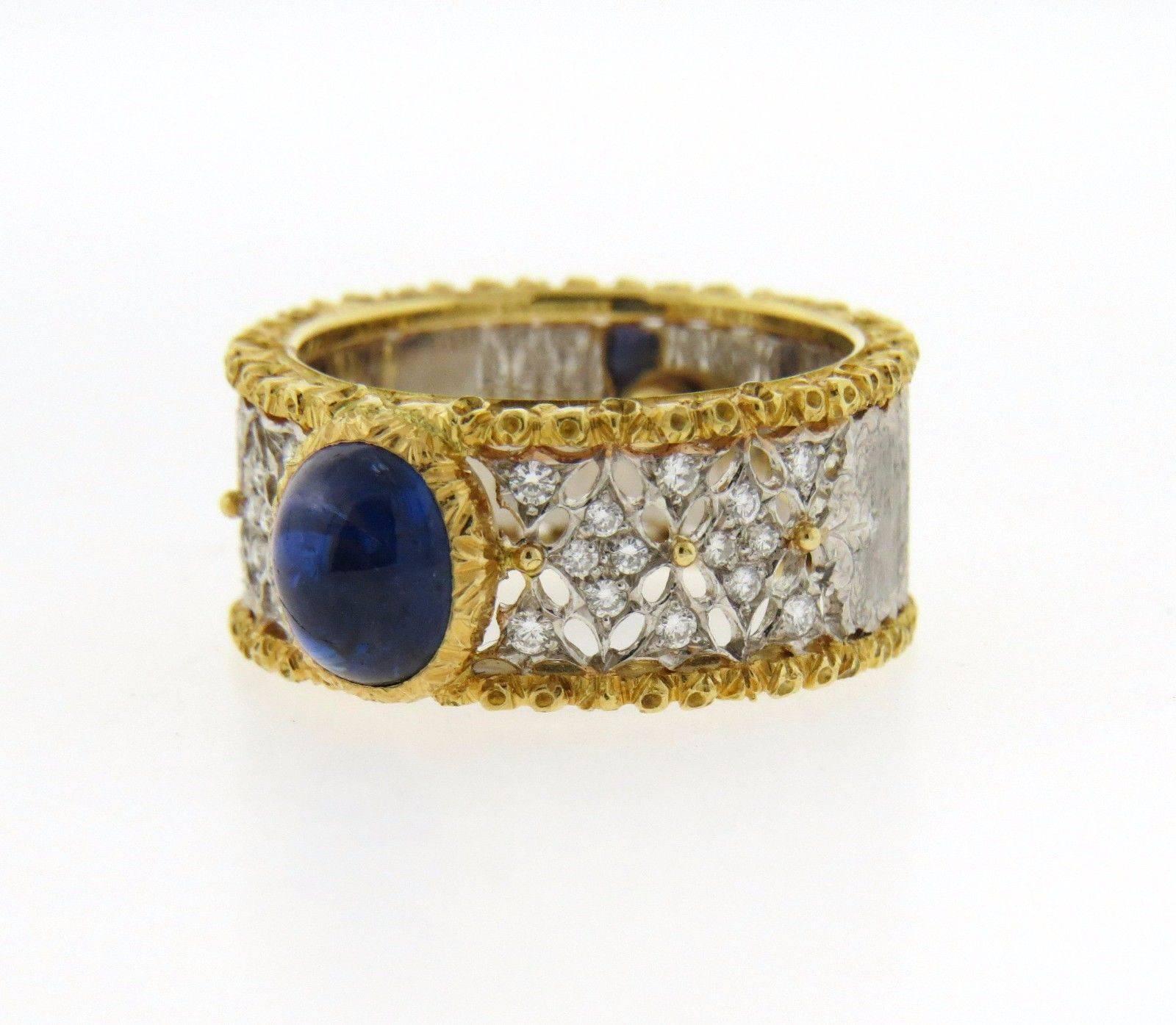 An 18K gold band ring set with a sapphire cabochon (7.2mm x 6mm) and diamonds. The ring size 6 (including sizing balls). Size can be increased by removing sizing balls. Band measures 9.3mm wide and weighs 8.2 grams.  Marked: Italy, 18K, 750,