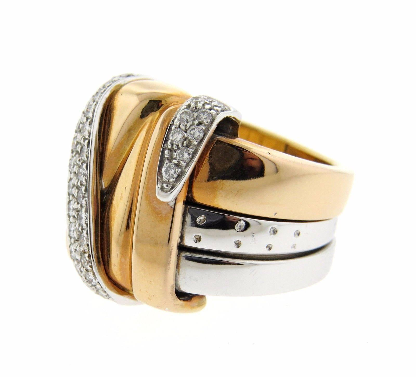 An 18k white and yellow gold ring set with approximately 0.26ctw of H/VS diamonds.  The ring is a size 6 3/4 and is 19.3mm at the widest point.  The weight of the piece is 26.7 grams.
