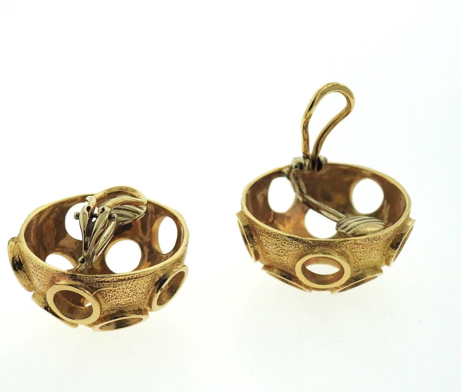 A pair of 14k yellow gold earrings resembling craters.  The earrings measure measure 26mm in diameter and sit approx. 14mm from the ear.  The earrings weigh 22.9 grams.
