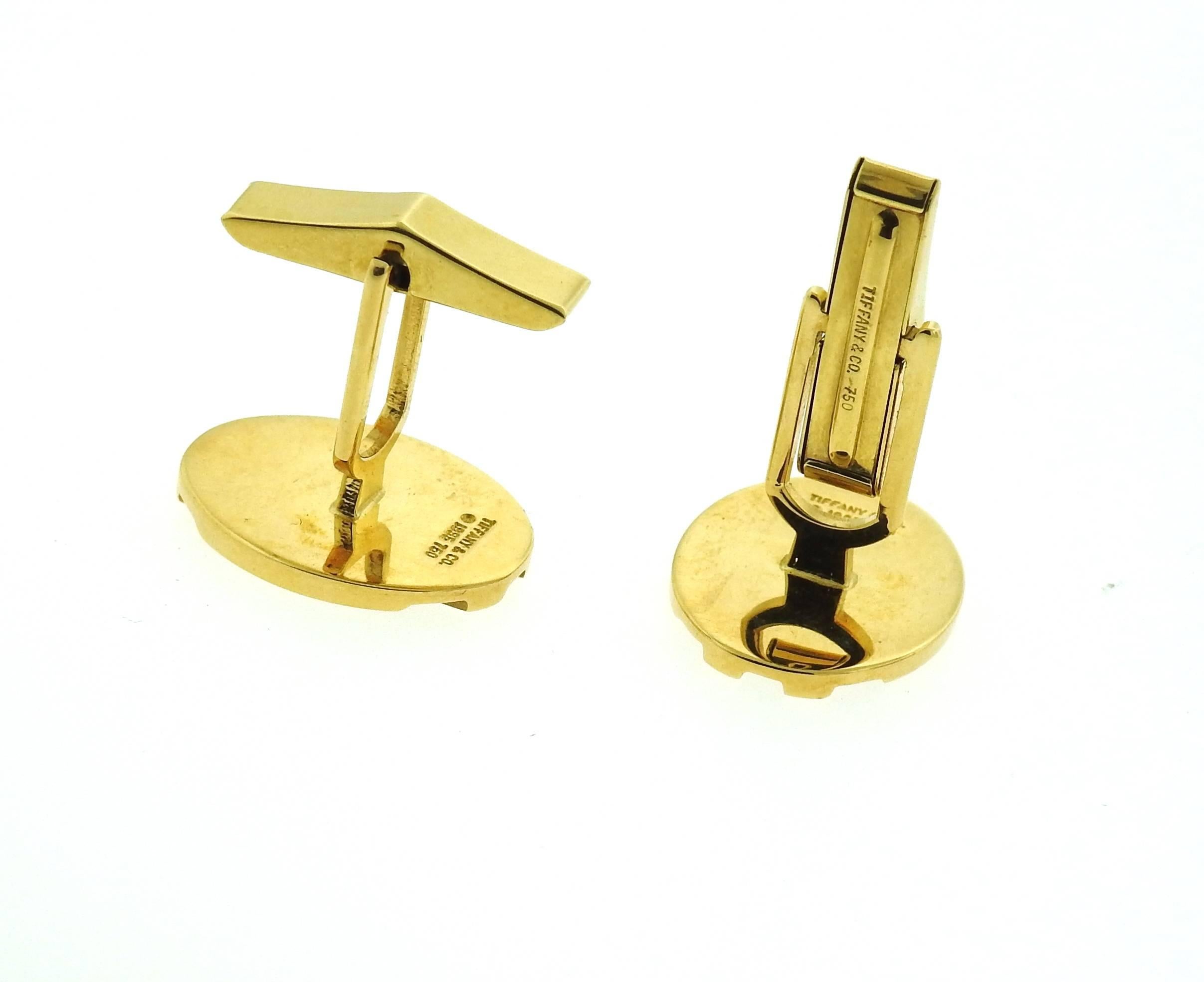 A pair of 18k yellow gold oval cufflinks, crafted by Tiffany & Co. Tops measure 19.7mm x 15mm. Marked: Tiffany & Co. 1995 750.. Weight - 15.6 grams