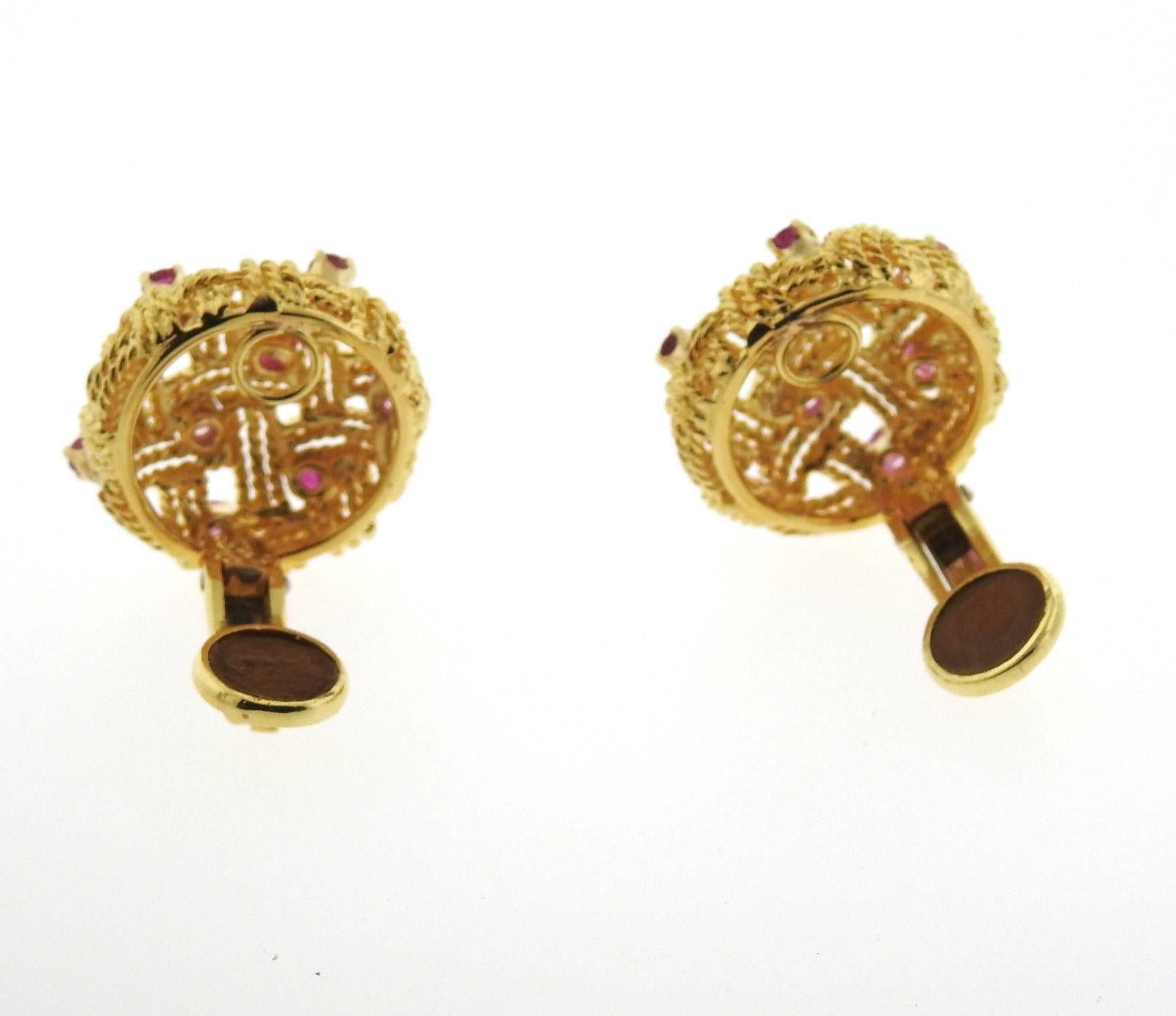 A pair of 18k yellow gold earrings set with rubies.  The earrings are 22mm in diameter and weigh 22.3 grams.