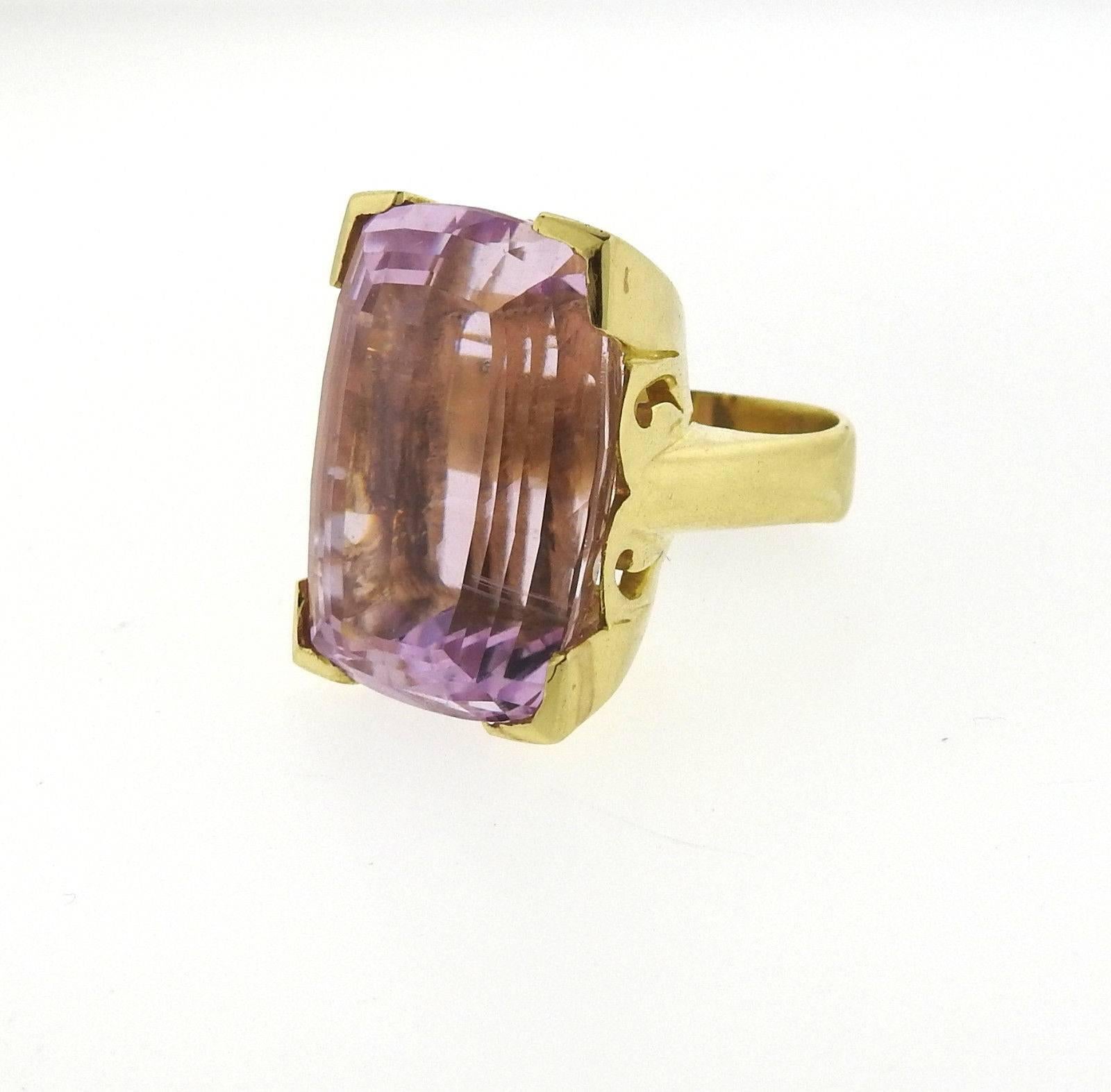 An 18k yellow gold ring set with a GIA certified 60.5 carat Kunzite (28.85mm x 20.78mm x 16.55mm).  The ring is a size 8 1/2 and weighs 42.3 grams. Comes with GIA cert for Kunzite.
