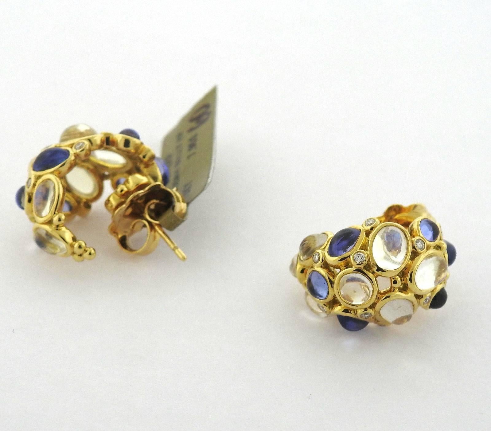 A pair of 18k yellow gold earrings set with tanzanite, moonstone, and approximately 0.08ctw of G/VS diamonds. The earrings measure 20mm x 15mm  and weigh 12.5 grams.  Marked: Temple mark, 750.  The retail of these earrings is $7950.