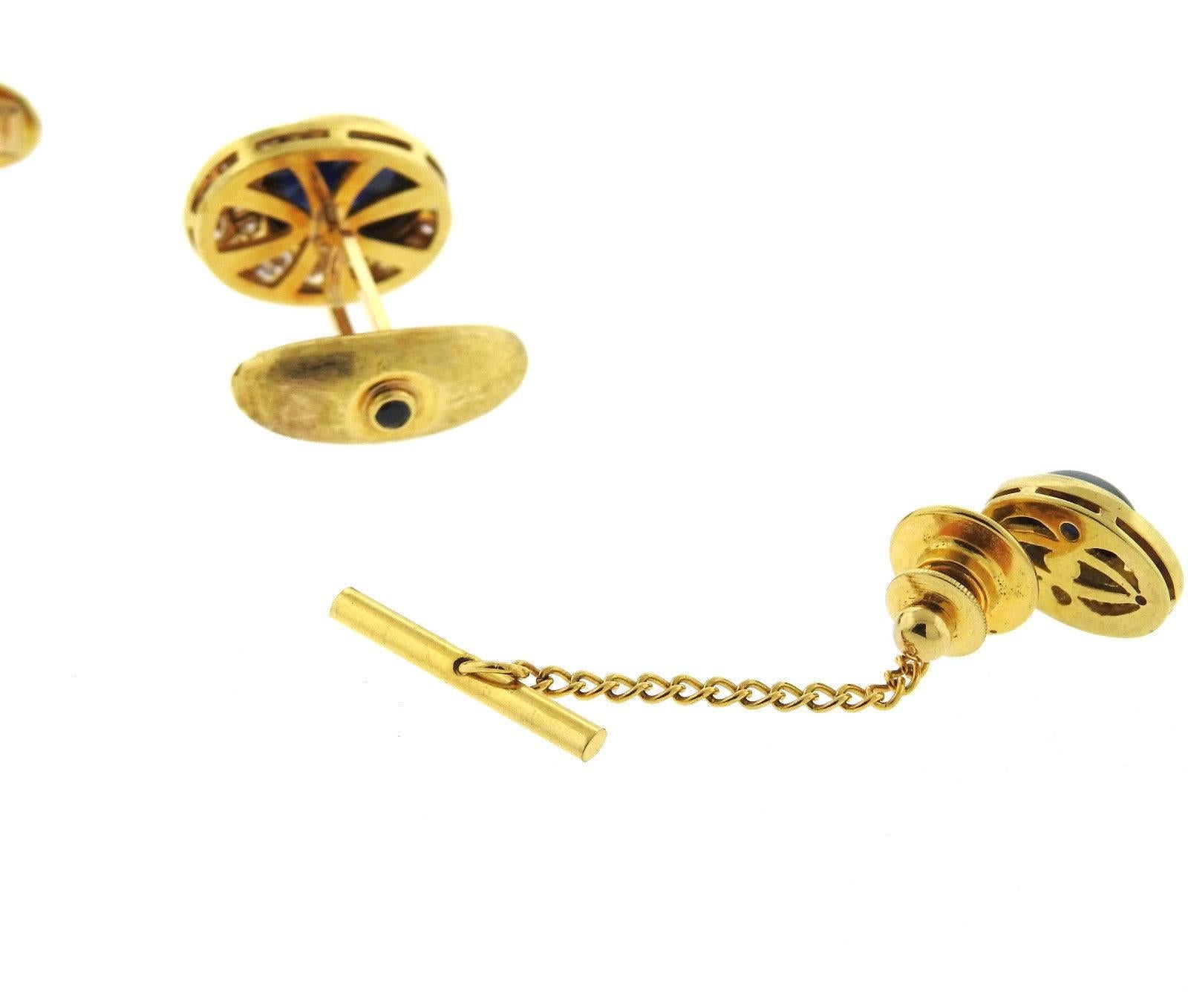 A pair 18k yellow gold cufflinks and tie tack set with approximately 2.00ctw of GH/VS diamonds and sapphire cabochons. Cufflinks measure 20mm x 15mm,  tie tack 15mm x 11mm.  The weight of the set is 27.5 grams.  Marked: E. Pearl, 18k (bar marked