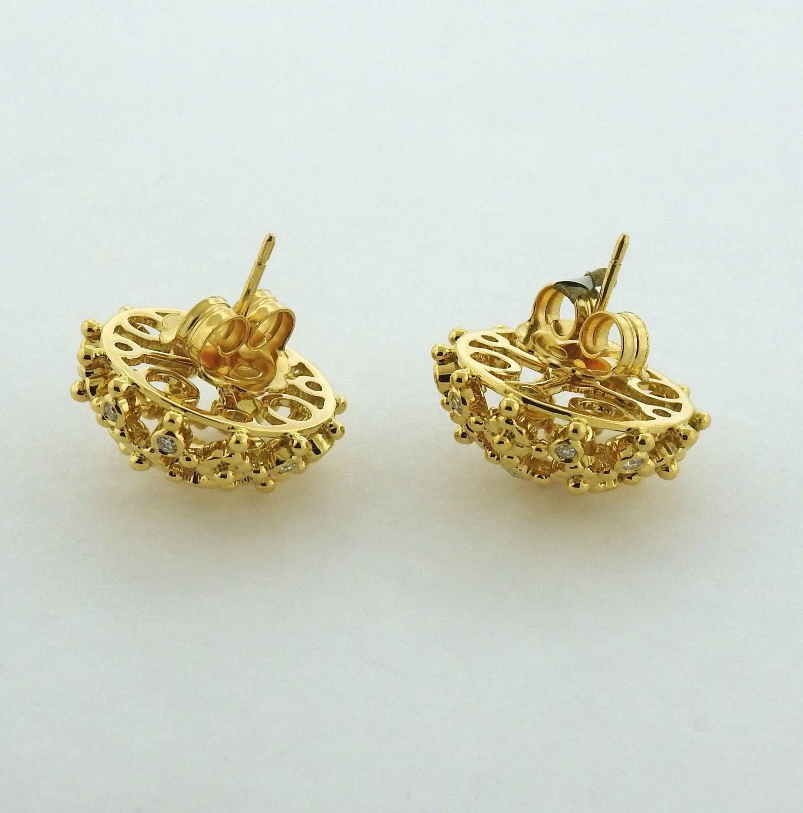 A pair of 18k yellow gold earrings set with 0.64ctw of G/VS diamonds.  The earrings are 20mm in diameter and weigh 13.5 grams.  The earrings currently retail for $4950.