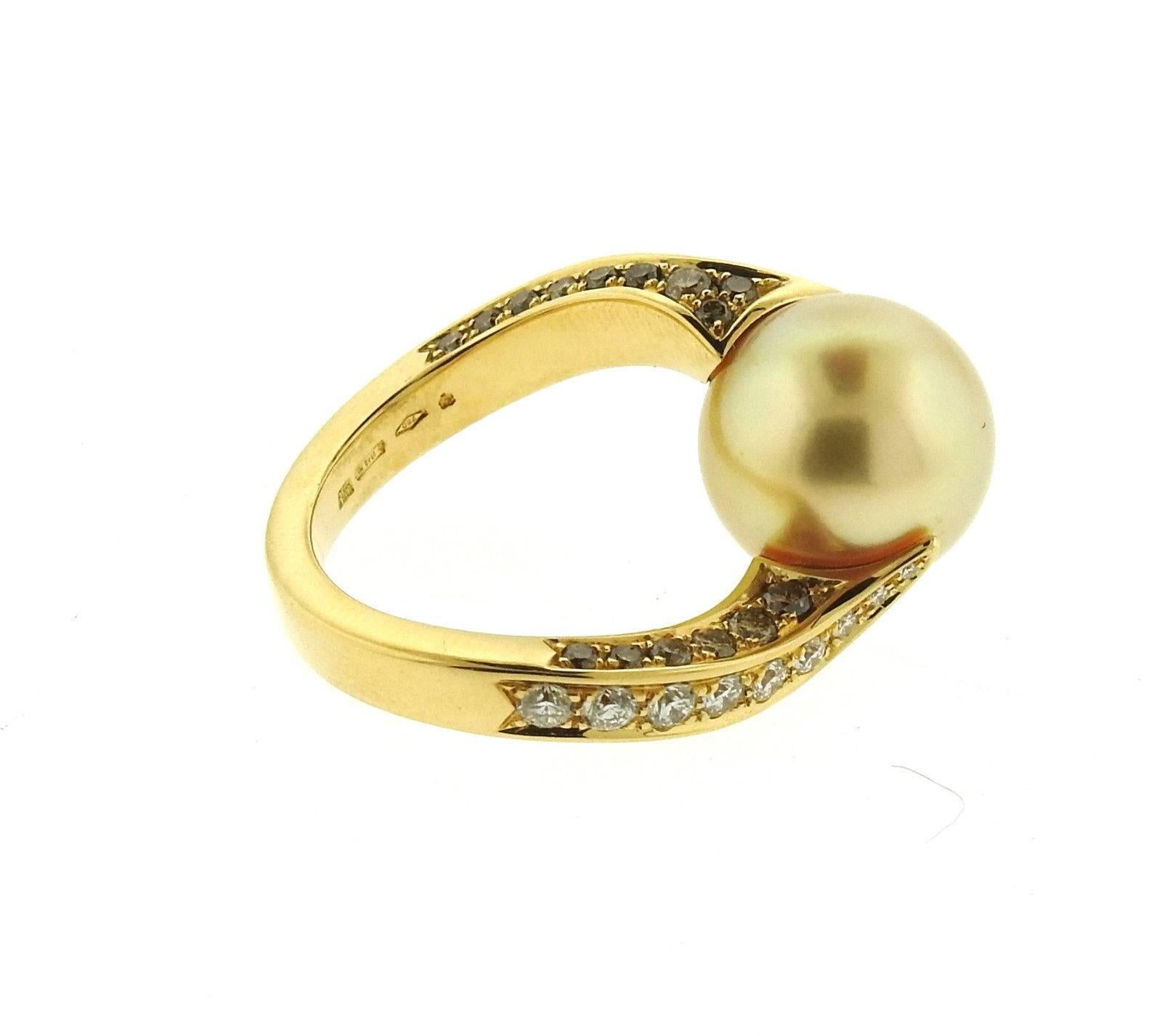 An 18k yellow gold ring set with a 12.5mm South Sea pearl and approximately 1.28ctw of G-Fancy/VS diamonds.  The ring is a size 6 1/4 and weighs 10.4 grams.  Marked: M hallmark, made in Italy, 750, 1840MI.   The retail of the ring is $12,650.