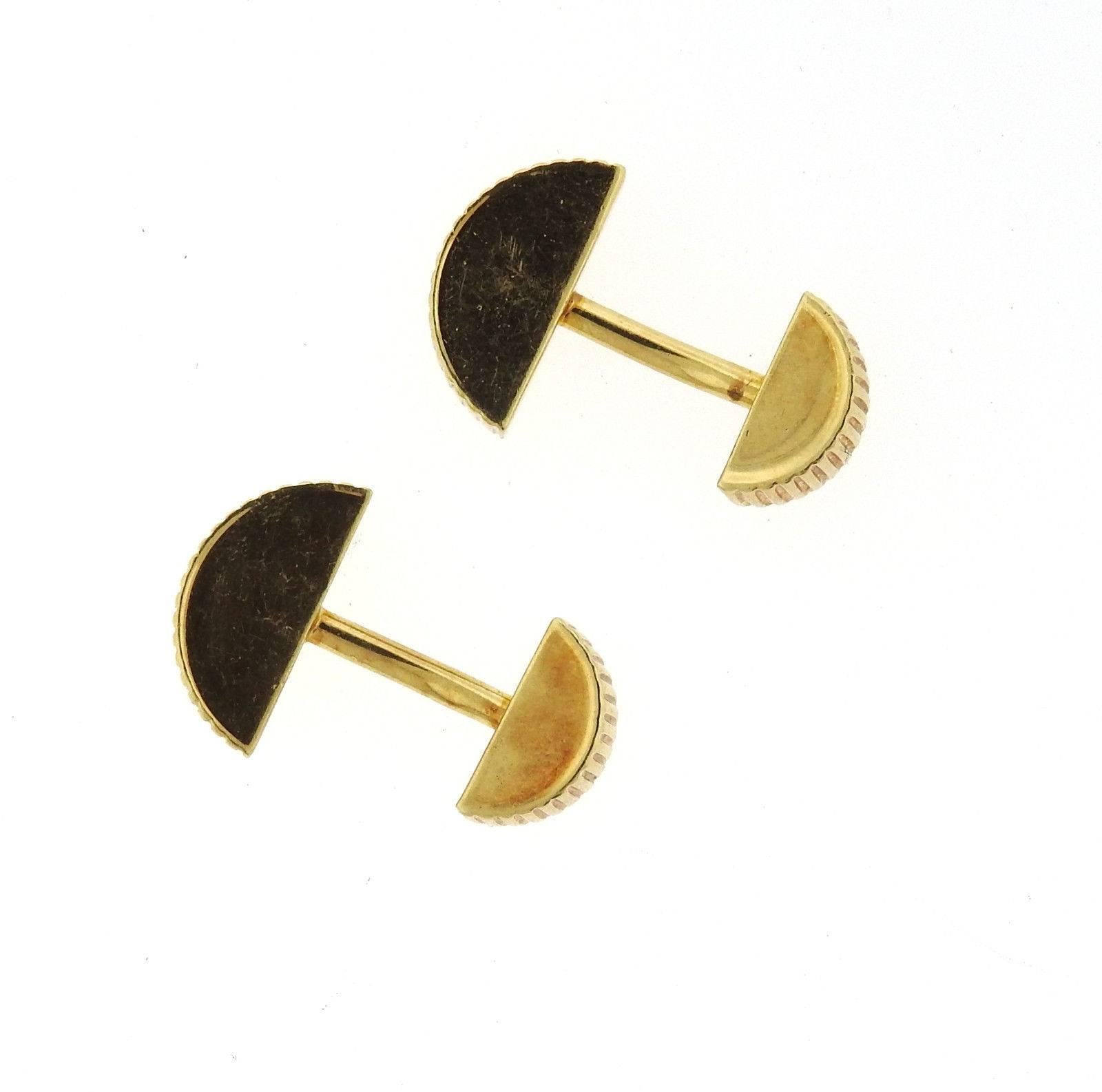 A pair of 18k yellow gold cufflinks by Tiffany & Co.  The cufflink tops measure 18mm x 8mm x 5mm.  Marked: T & Co, 750, 2003.  The weight of the cufflinks is 26.5 grams.