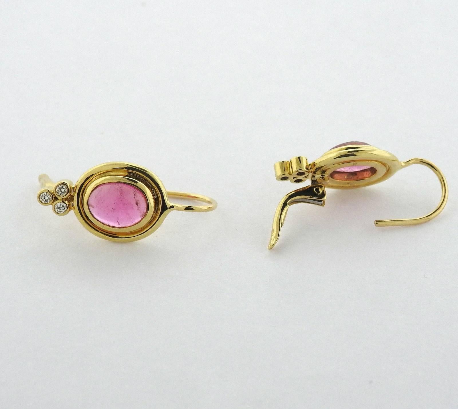 A pair of 18k yellow gold earrings set with pink tourmaline cabochons and approximately 0.09ctw of G/VS diamonds. The earrings are 22mm x 10mm and weigh 5.3 grams.  Marked with the Temple mark and 750.  The earrings currently retail for $2300. 
