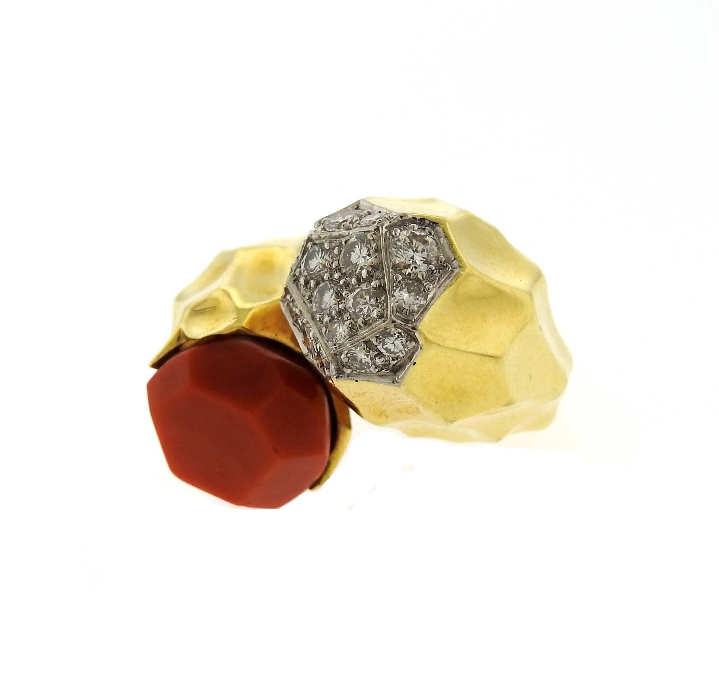 An 18k yellow gold ring set with coral and approximately 0.90ctw of G/VS diamonds.  The ring is a size 5.75, ends measure 15.5mm and 13.3mm in diameter. Ring is 24mm at widest point.  Marked: Kutchinsky, English Assay marks. The weight of the ring