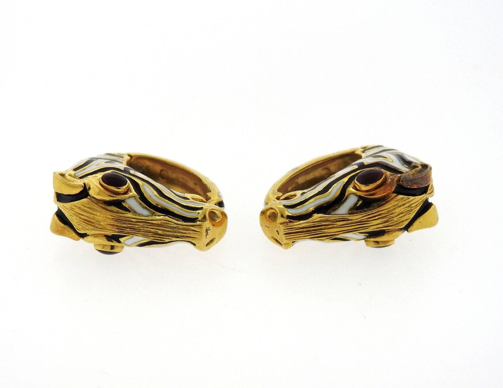 A pair of 18k yellow gold cufflinks set with ruby cabochons.  Each top (zebra head) measures 25mm x 12mm.  Marked: Webb 18k (partially visible).  The weight of the set is 30 grams.