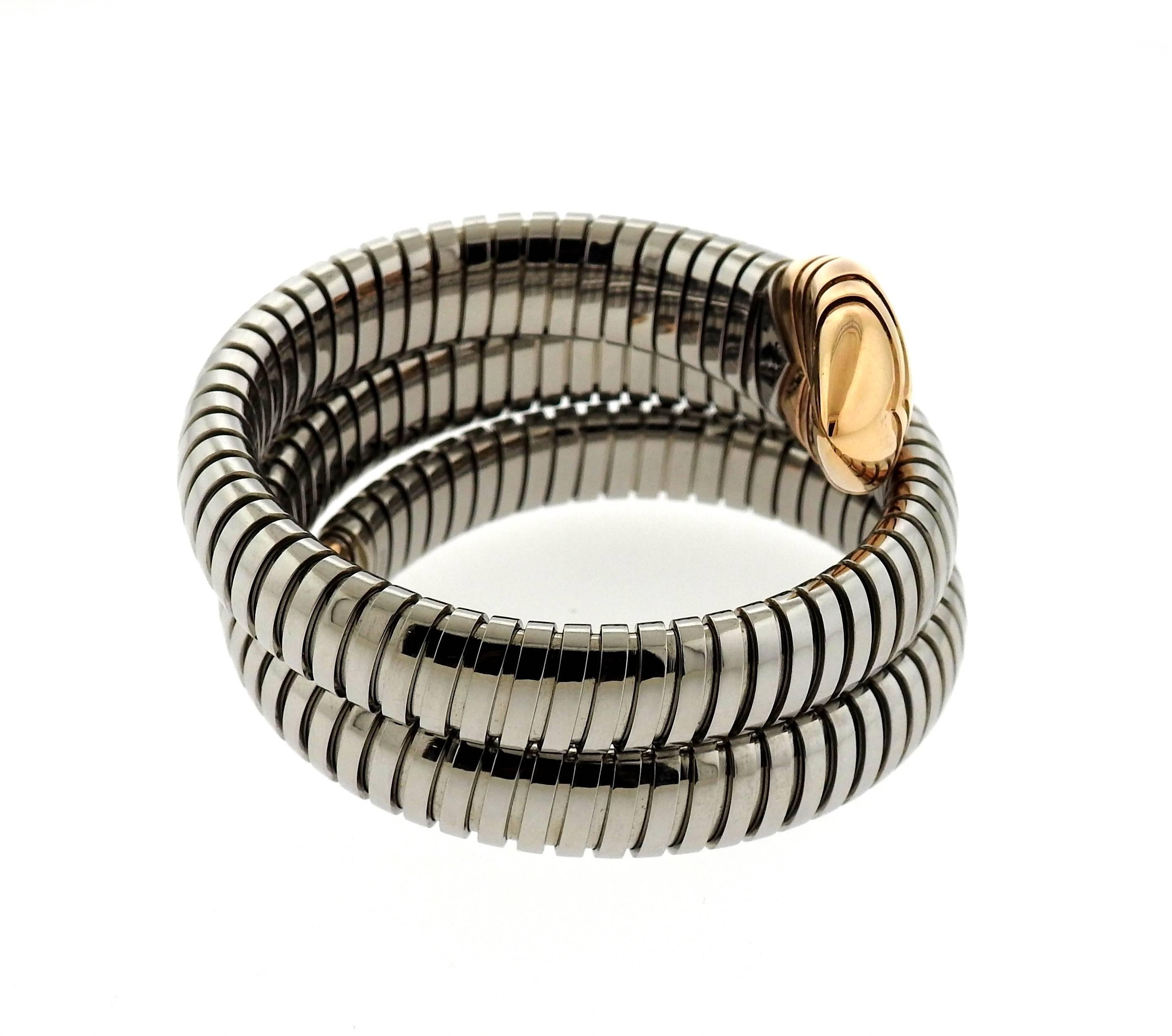 An 18k gold and stainless steel tubogas bracelet.  The bracelet will fit up to a 6 1/2