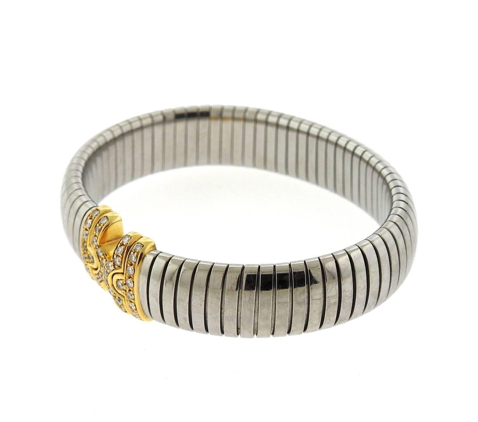 A stainless steel and 18k gold bracelet set with  G/VS diamonds.  The bracelet will fit up to 7