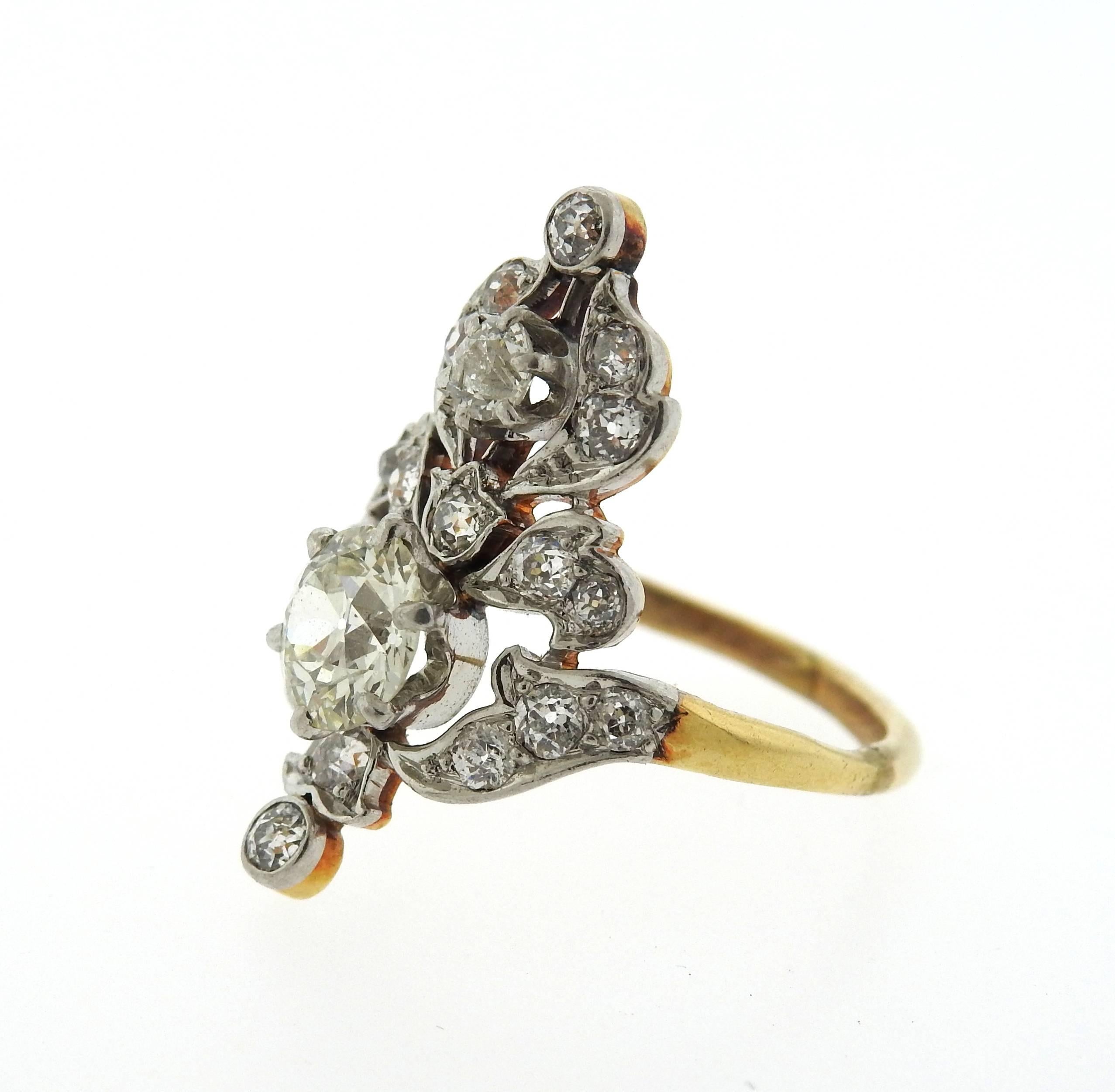 Antique 14k gold and platinum ring, featuring Old European cut center diamond 6.5mm X 6.45mm X 3.7mm. ( approx. 0.96ctw ) VS/SI-GH.  Surrounded with approx. 0.50ctw old mine cut diamonds. Ring size 5 1/2. Top measures 24mm x 16.5mm. Weight of the