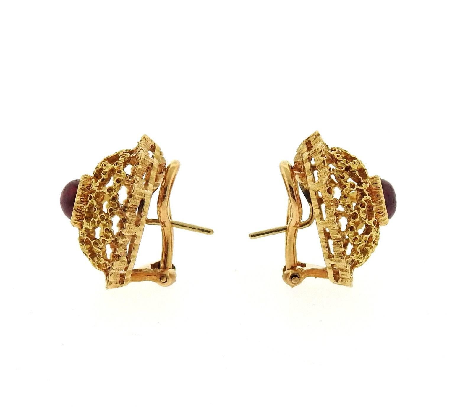 A pair of 18k yellow gold earrings set with 5mm ruby cabochons.  Earrings are 20mm in diameter and weigh 10.4 grams.  Marked: Buccellati, 18k, Italy. 