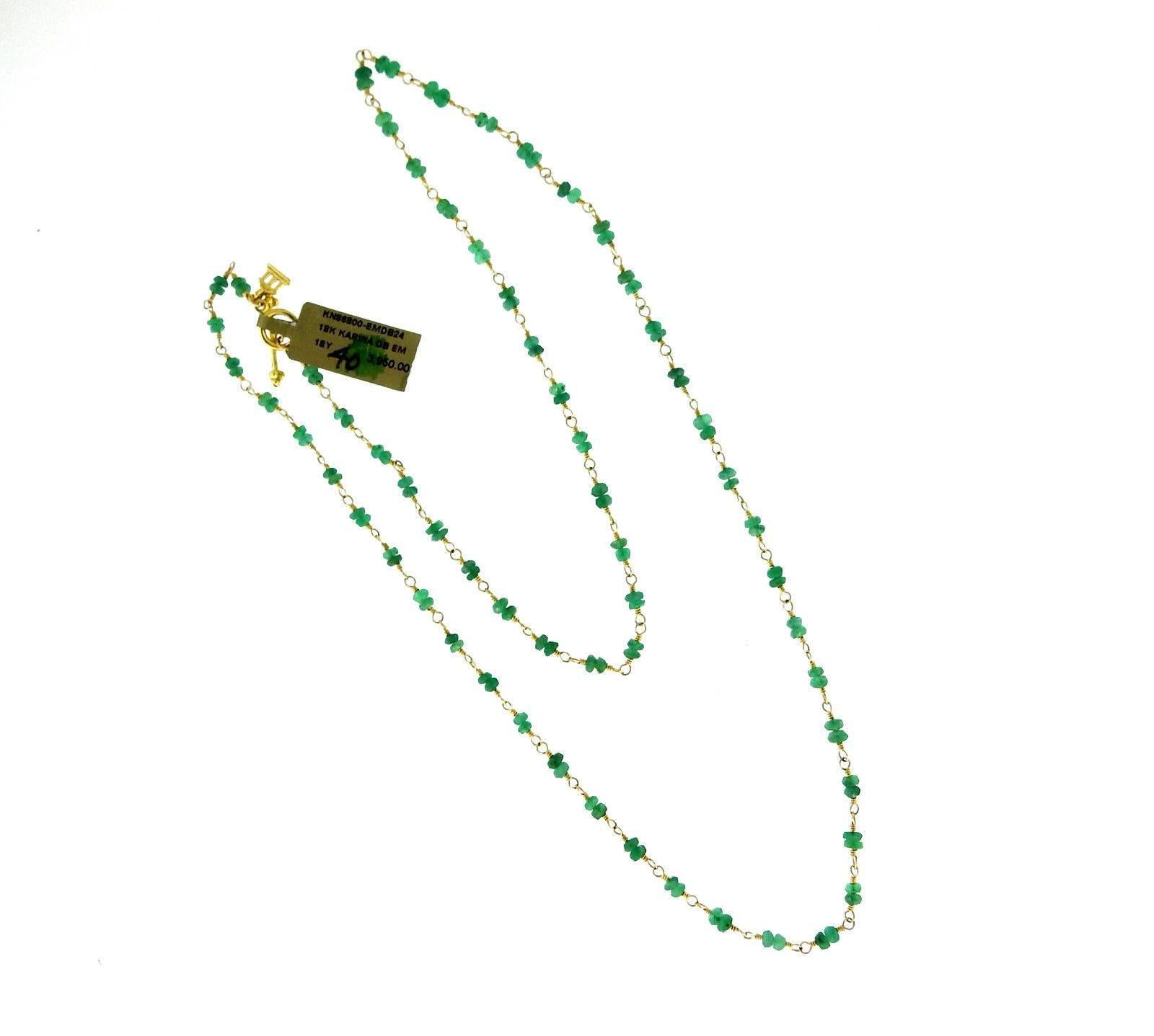 An 18k yellow gold necklace set with emerald beads (3mm-3.4mm).  The necklace is 24