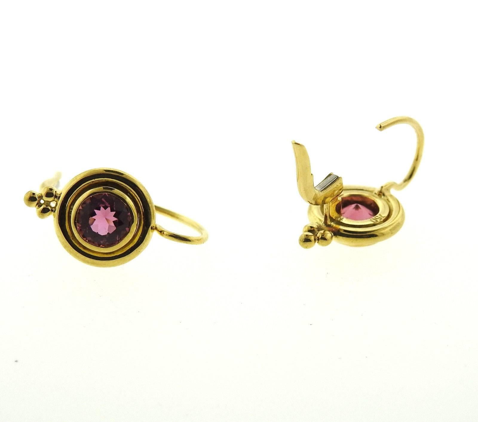 A pair of 18k yellow gold earrings set with pink tourmalines.  The earrings measure 19mm x 10mm and weigh 5.4 grams.  Marked: Temple mark, 750.  The earrings currently retail $2300.