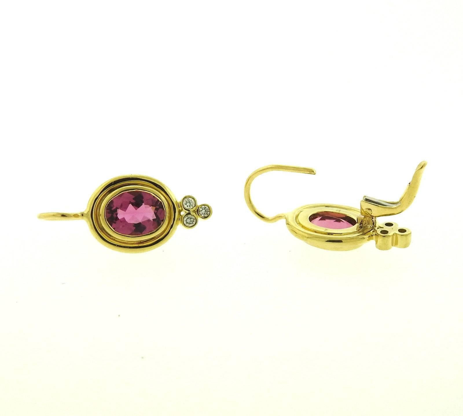A pair of 18k yellow gold earrings set with pink tourmalines and approximately 0.09ctw of G/VS diamonds.  The earrings are 23mm x 10mm and weigh 5.3 grams.  Marked: Temple Hallmark, 750. The retail is $2950.