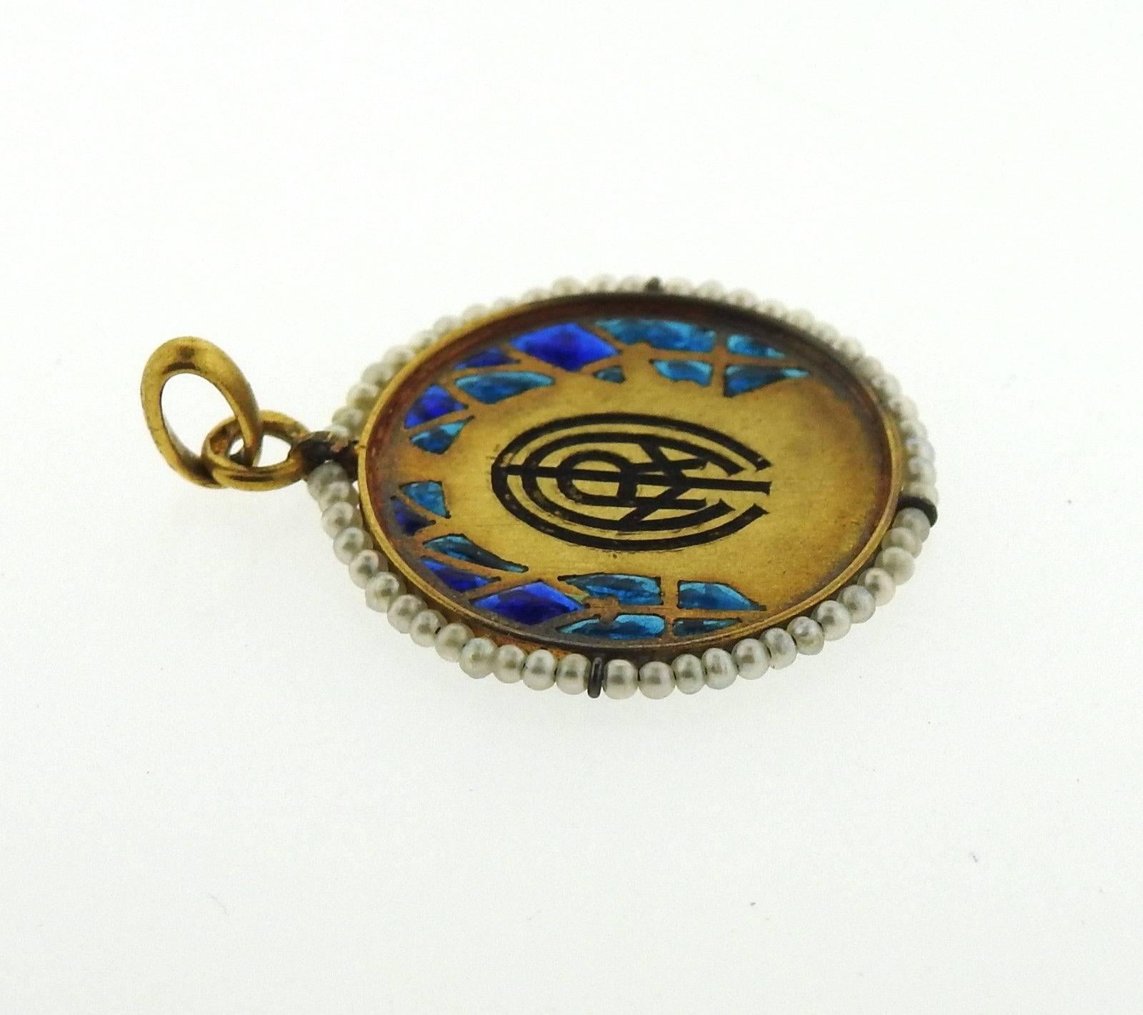 An 18k gold pendant set with seed pearls and plique a jour enamel. Marked: HC 224.  The weight of the piece is 3 grams.
