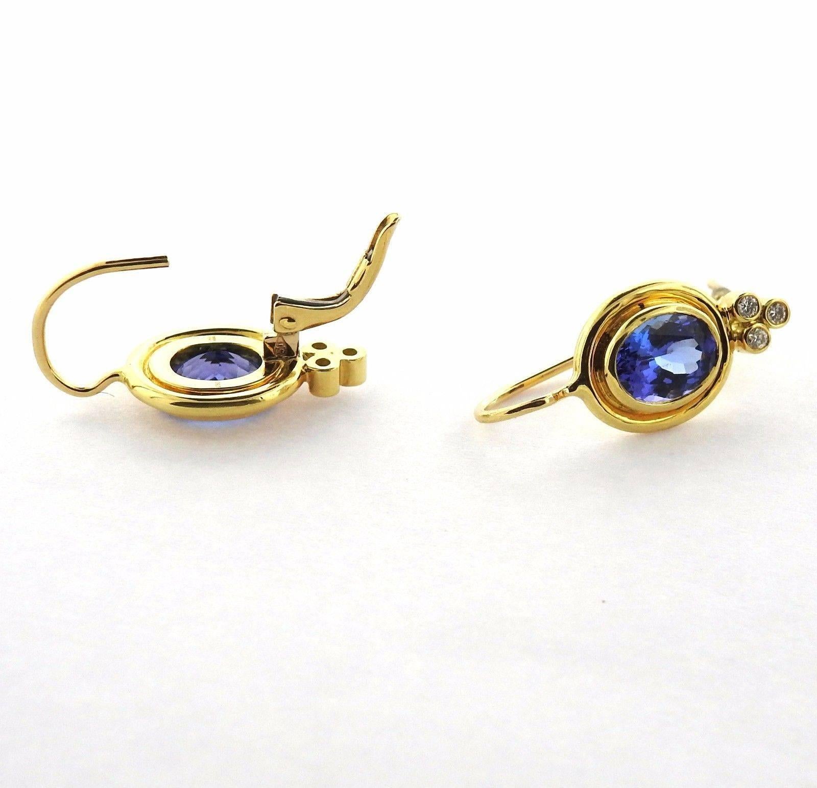 A pair of 18k yellow gold earrings set with faceted tanzanite and approximately 0.09ctw of G/VS diamonds.  The earrings are 24mm (including wire) x 10.4mm.  The weight of the pair is 5.7 grams.  Marked: Temple Mark, 750.  The current retail is $6950