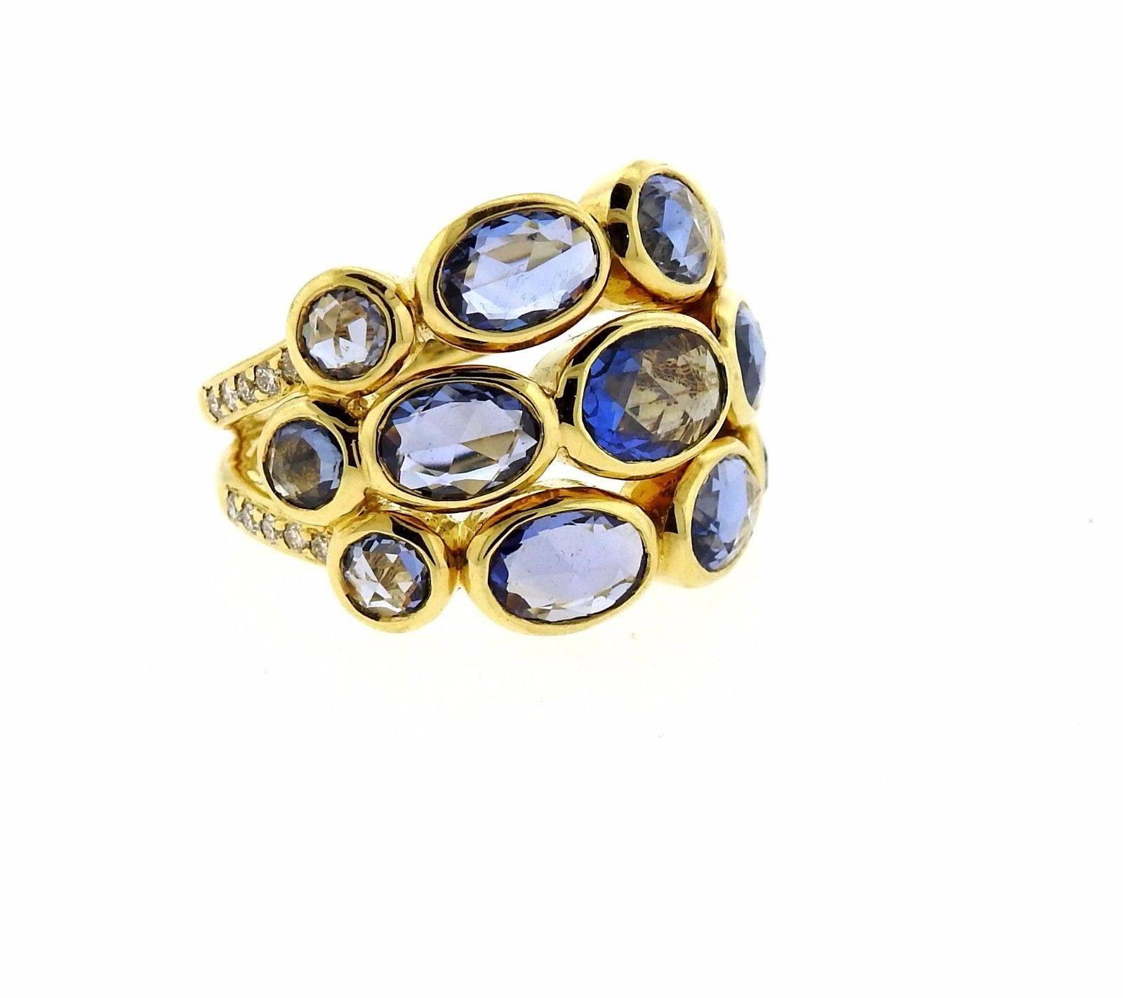 An 18k yellow gold ring set with rose cut blue sapphires and 0.23ctw of G/VS diamonds.  The ring is a size 6.75. Ring top is 17.8mm at widest point.  Marked:	Temple mark, 750.  The weight of the piece is 14.5 grams. The retail is $5950.
