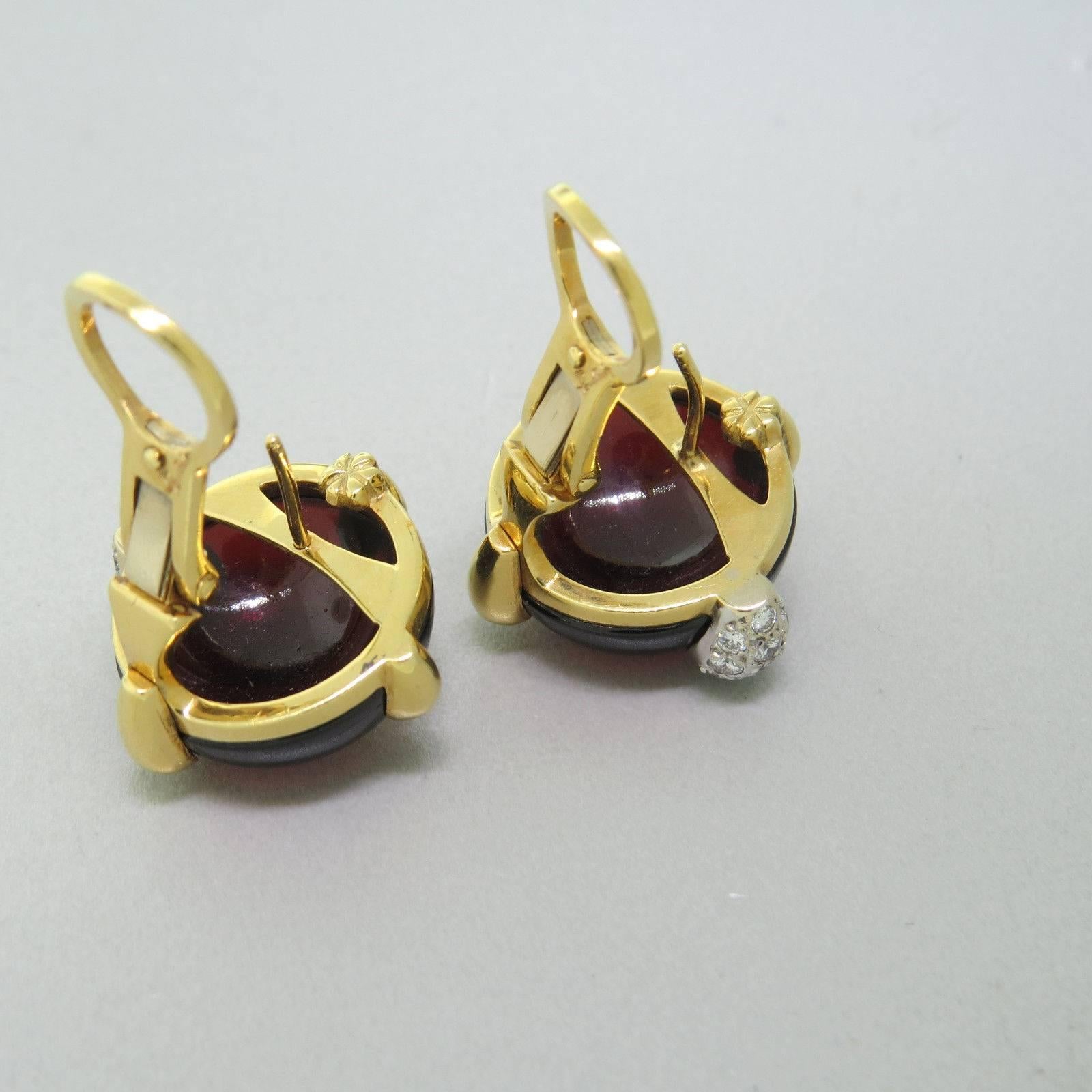 A pair of 18k gold cabochon earrings. Crafted by Pomellato featuring approximately 0.40ctw in G/VS diamonds and garnet. Earrings-21mm x 23mm. Marked 750, Pomellato. Weight- 21.3 grams.