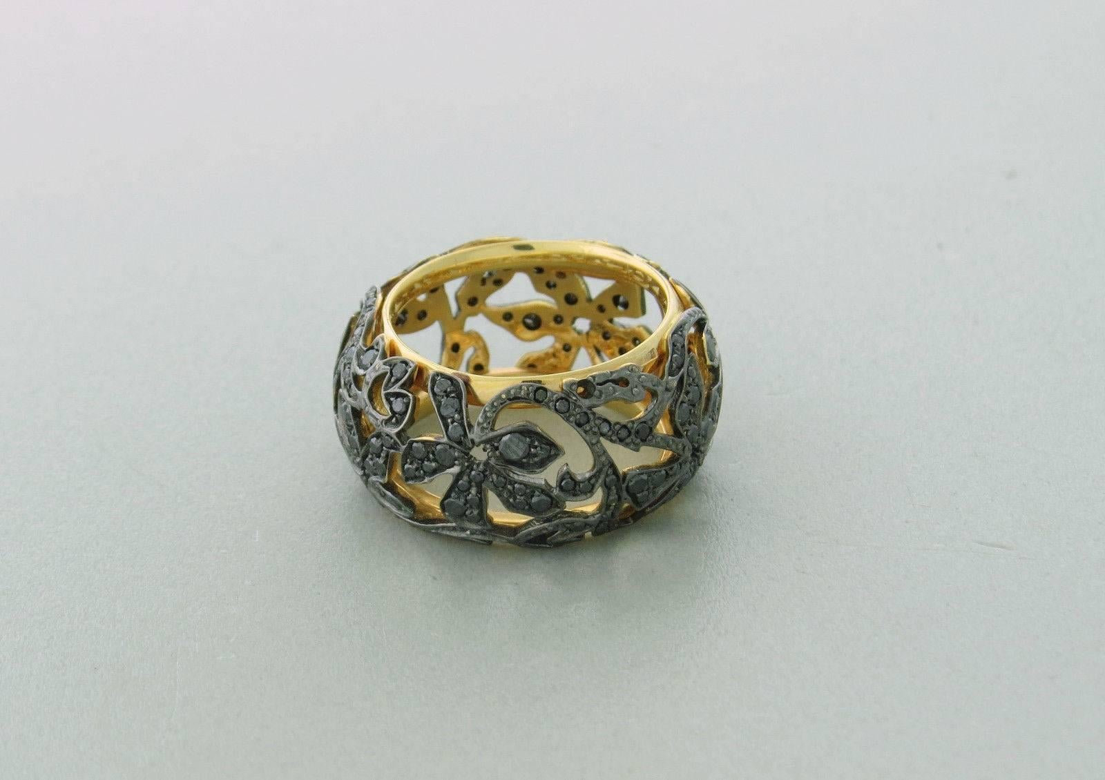 Pomellato 18k rose gold band ring crafted for the Arabesque collection. Features black diamonds. Ring measures 12mm, Size 7. Marked 750, Pomellato, P100006393. Weight- 10.3 grams. Retails for $8420.