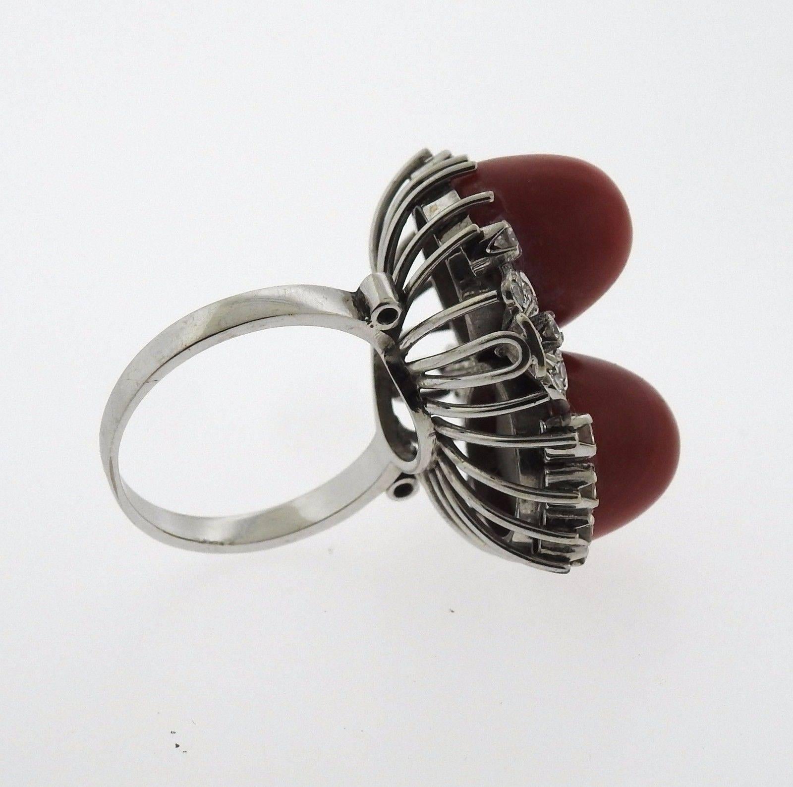 An 18k white gold ring set with coral (12mm x 13mm) and approximately 0.75ctw of H/VS diamonds.  The ring is a size 7.5 and the top measures 28mm x 24mm.  The weight of the piece is 13.5 grams.