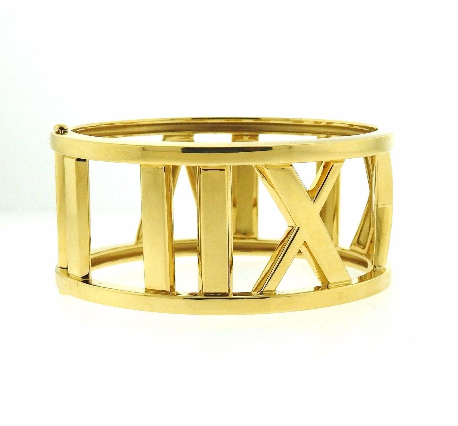 An 18k yellow gold bangle bracelet from the Atlas collection by Tiffany & Co.  The bangle will comfortably fit up to 6 3/4