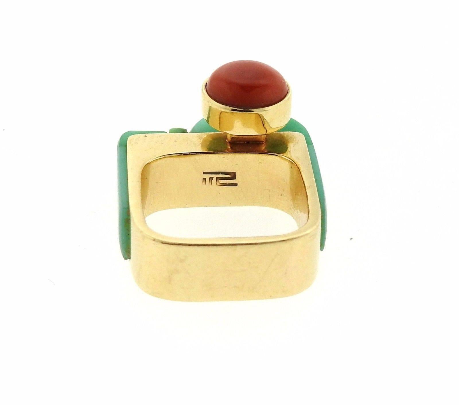 A 14k yellow gold ring set with jade and coral.  The ring is a size 6 3/4 and the ring top 15mm wide.  The weight of the piece is 11.9 grams.  Marked with the makers hallmark. 