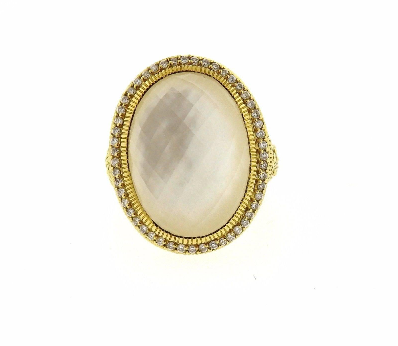 An 18k yellow gold ring set with a faceted quartz over mother of pearl and approximately 0.41ctw of G/VS diamonds.  The ring is a size 7, ring top is 26mm x 23mm.  The weight of the ring is 18 grams.  Marked: 7, JR, 18k.