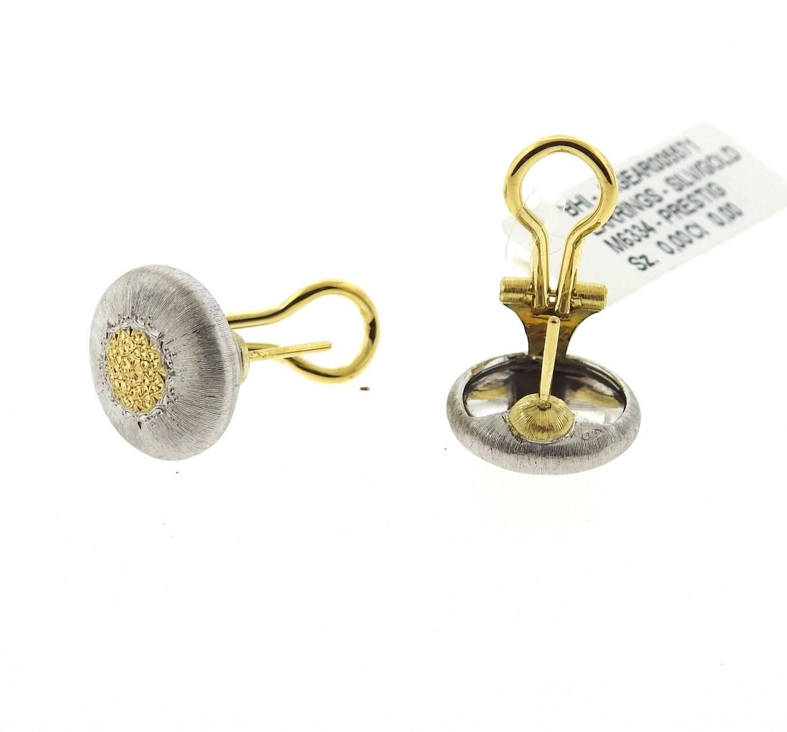 A pair of 18k yellow gold and sterling silver earrings by Buccellati.  The earrings measure 15mm in diameter and weigh 7.5 grams. Marked: Buccellati, Italy, 18k, M6334. 