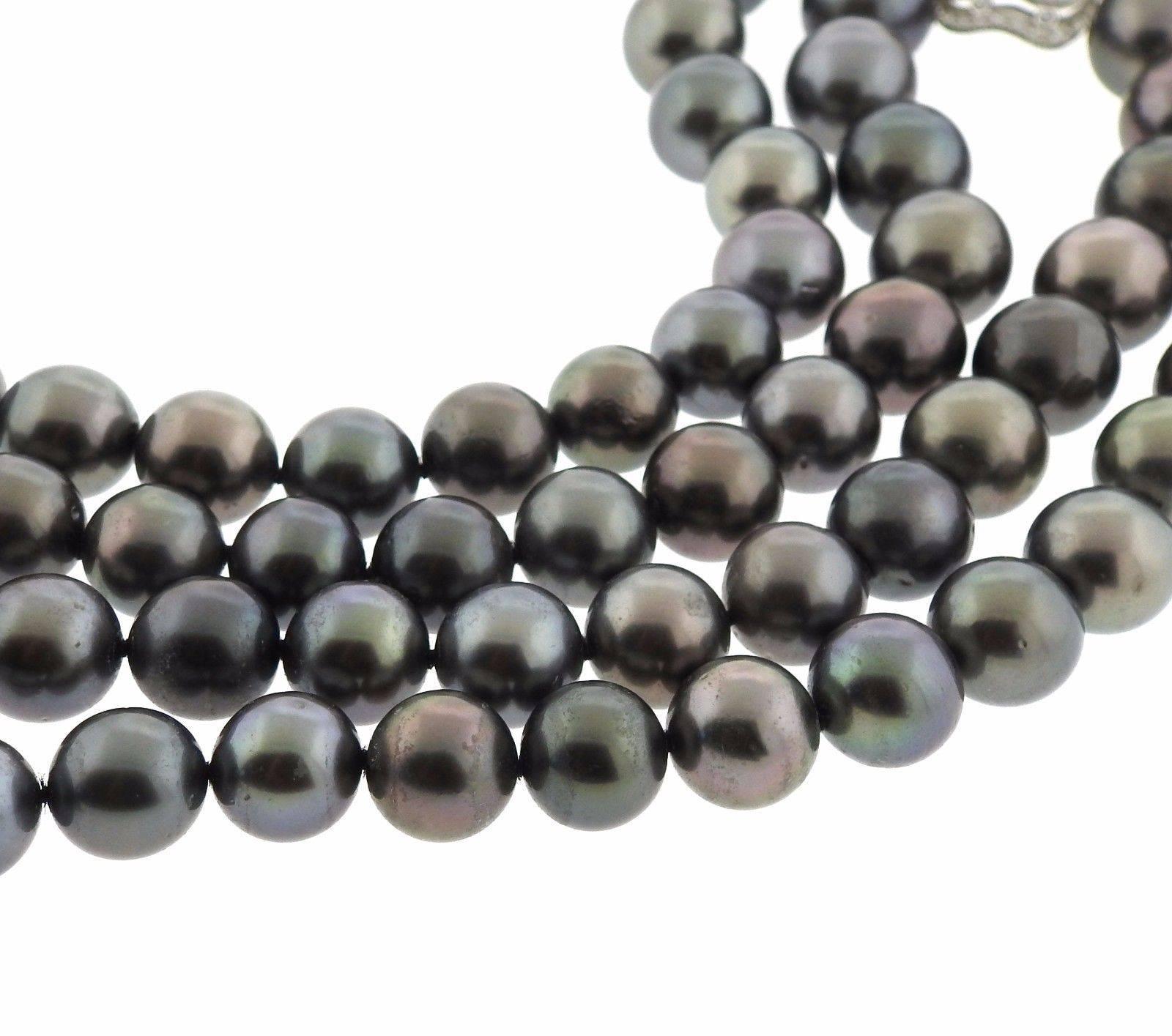 A platinum and 18k gold necklace set with Tahitian pearl ranging in size from 9mm - 12mm and 3.80ctw of G/VS diamonds.  The necklace is 17