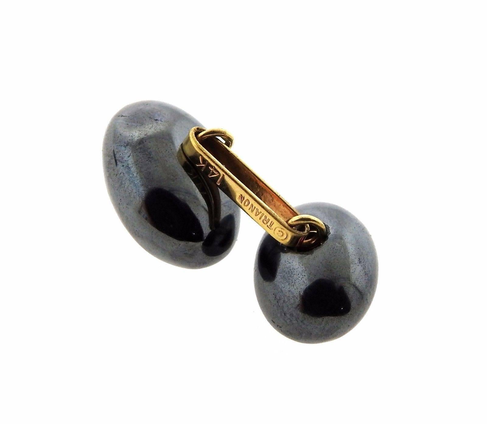 A pair of 14k gold cufflinks set with hematite and approximately 0.06ctw of G/VS diamonds. The cufflink tops measure 16mm x 12mm, backs measure 14mm x 10mm.  The weight of the cufflinks is 16.1 grams.
