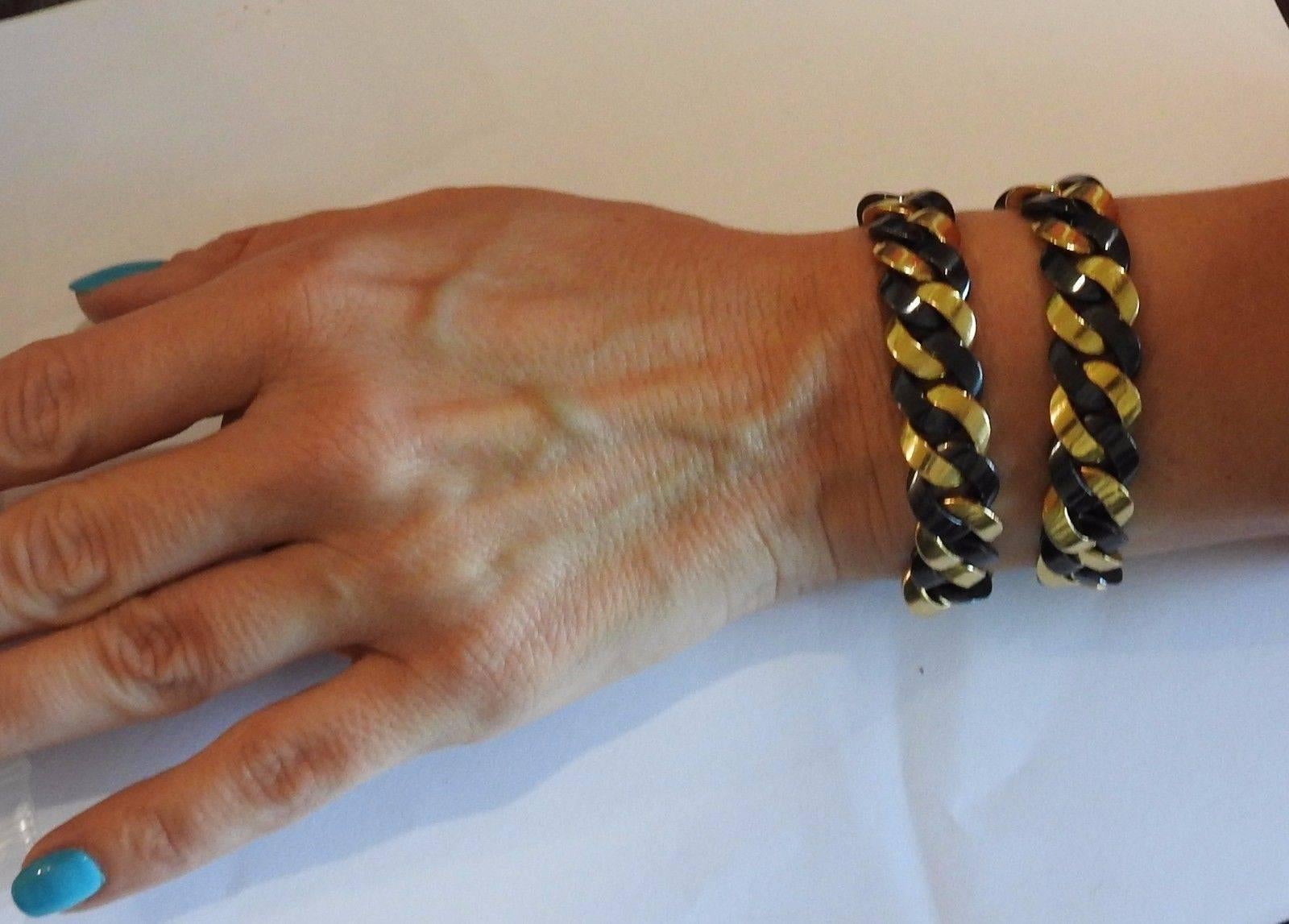 A pair of 18k yellow gold and gunmetal bracelets measuring 7 1/4