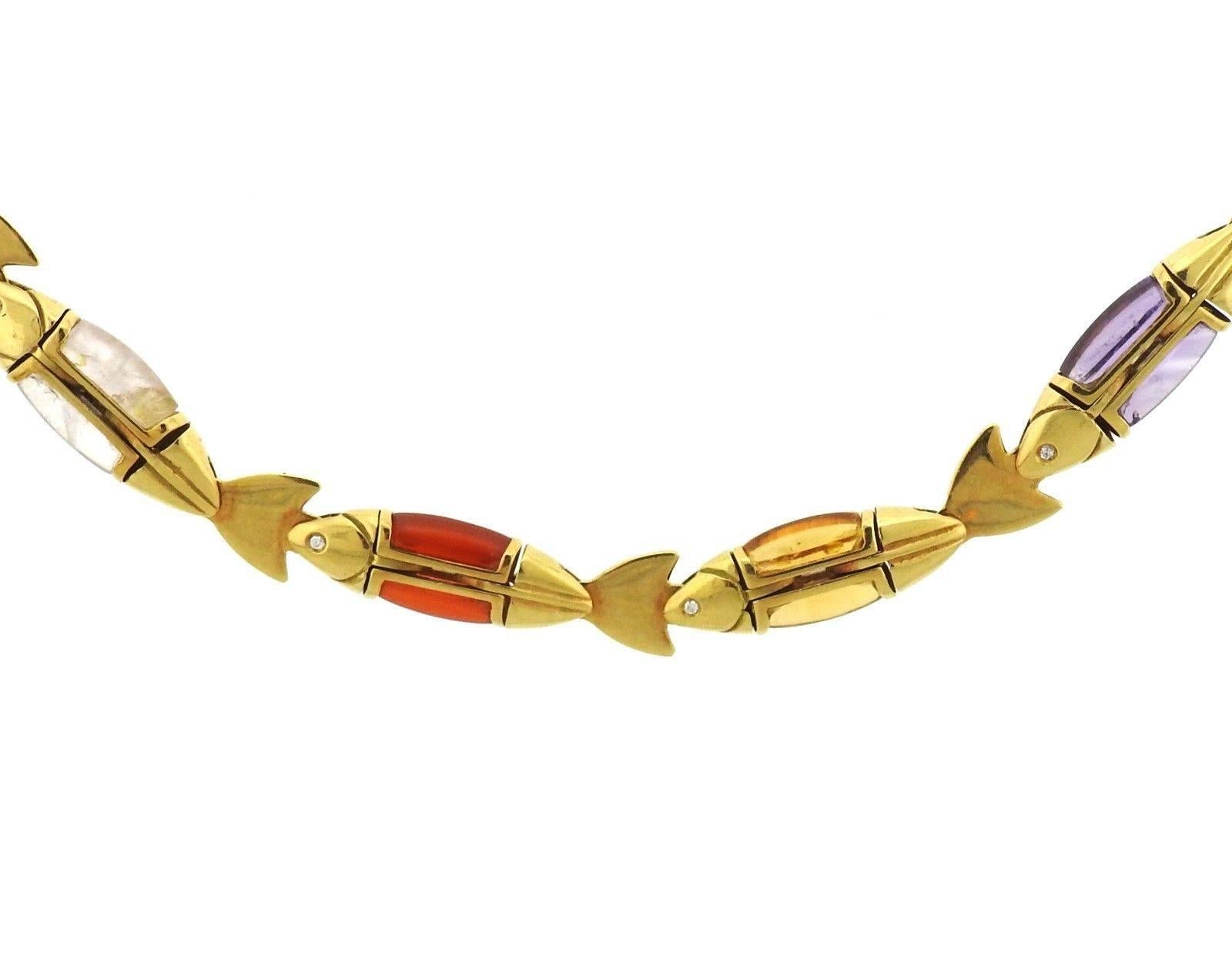 An 18k yellow gold necklace set with multicolor gemstones and diamonds.  The necklace is 19