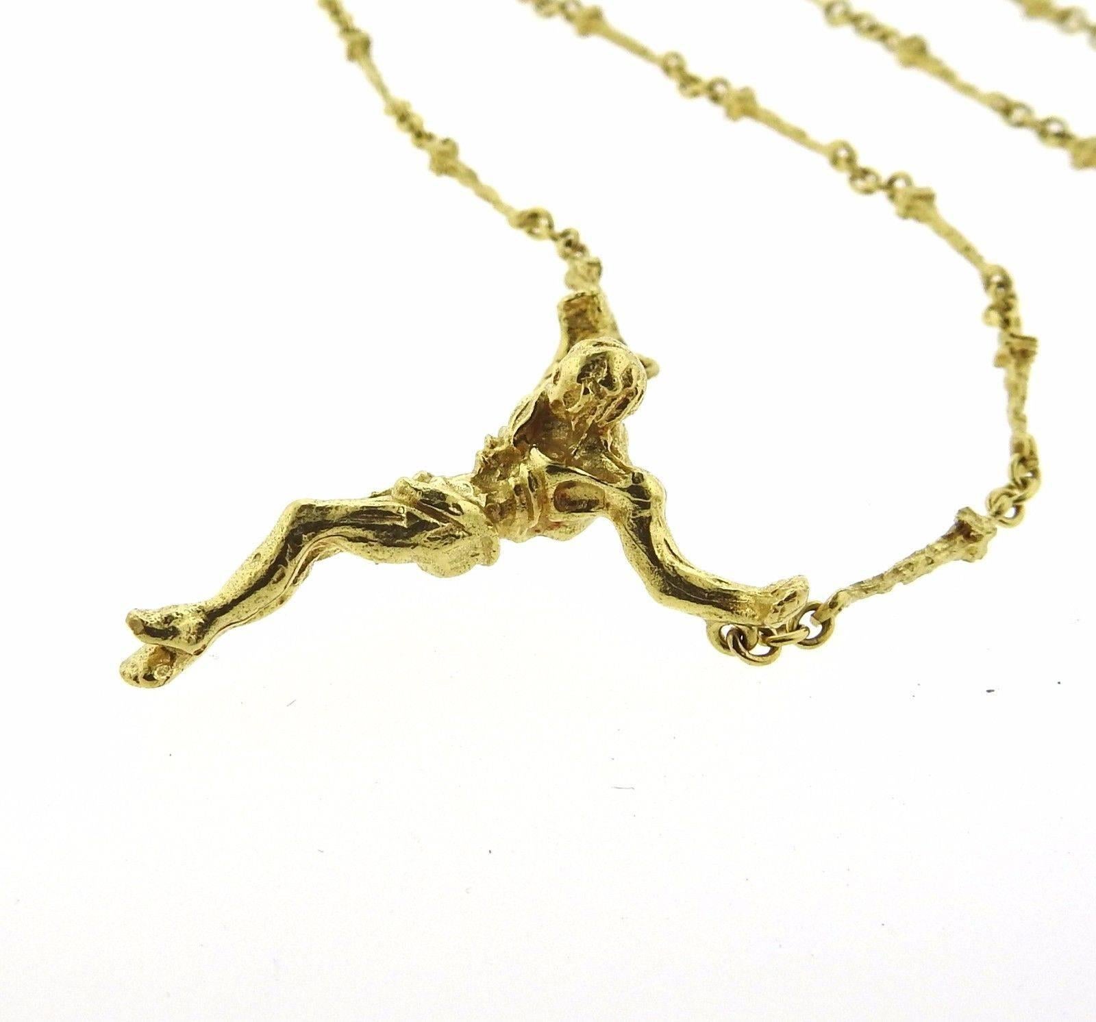 An 18k yellow gold cross pendant necklace.  The necklace is 24