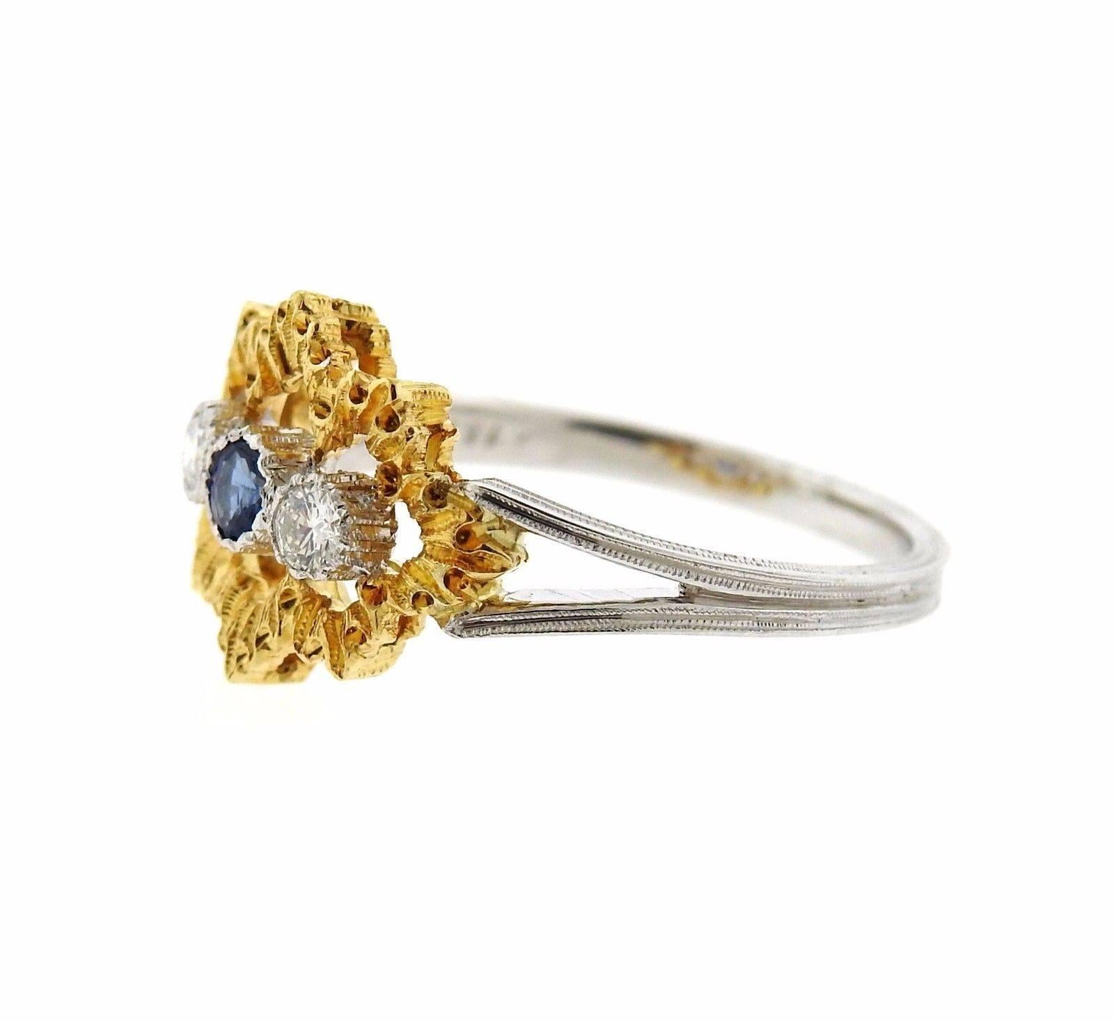 An 18k yellow and white gold ring set with a sapphire and approximately 0.08ctw of H/VS diamonds.  The ring is a size 6, ring top is 11mm x 14mm.  The weight of the piece is 3 grams.  Marked:  Gianmaria Buccellati Italy 18k.  Retail is $7710. Comes