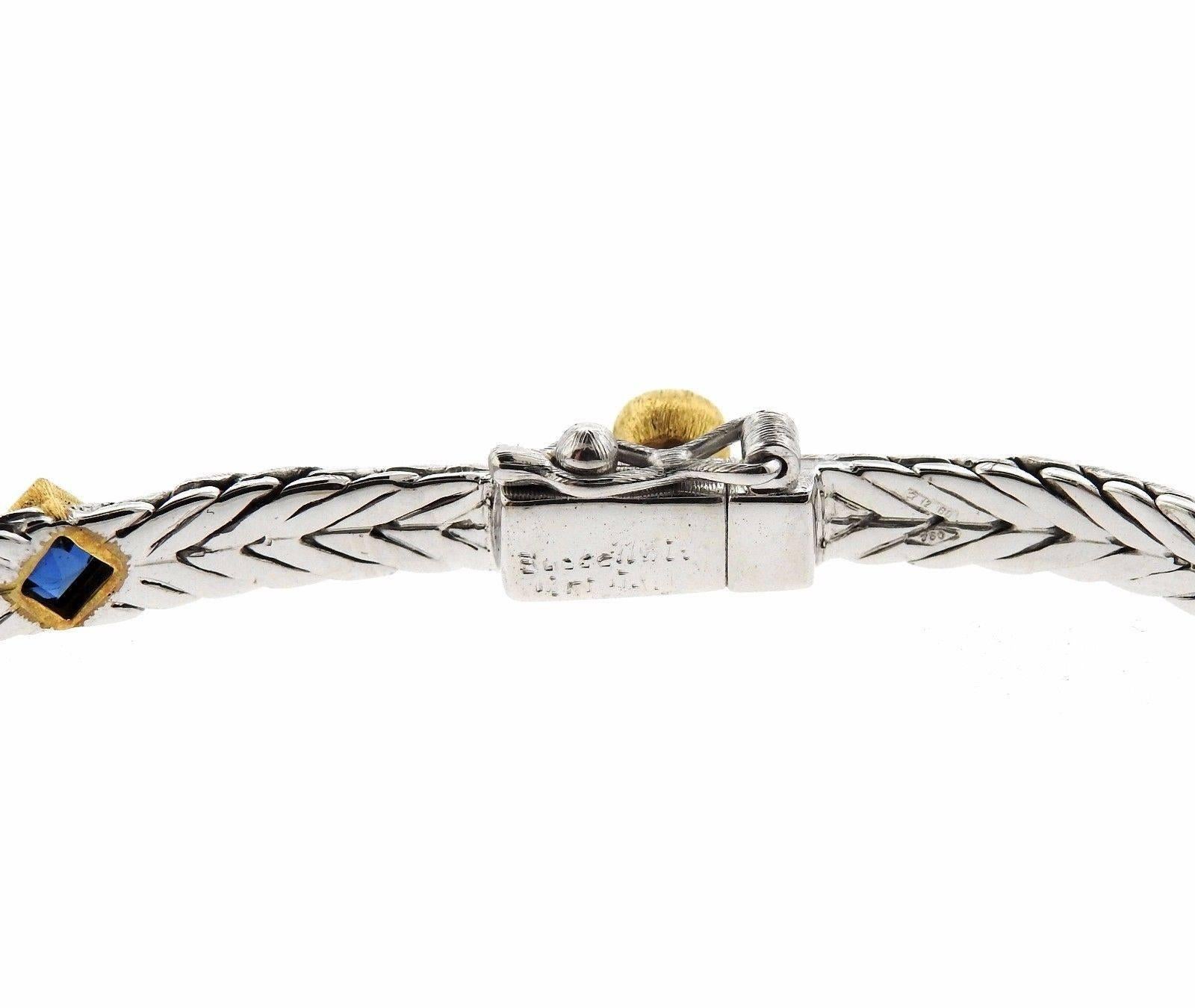 An 18k yellow and white gold bracelet set with sapphires and approximately 0.34ctw of H/VS diamonds.  The bracelet is 7 1/8