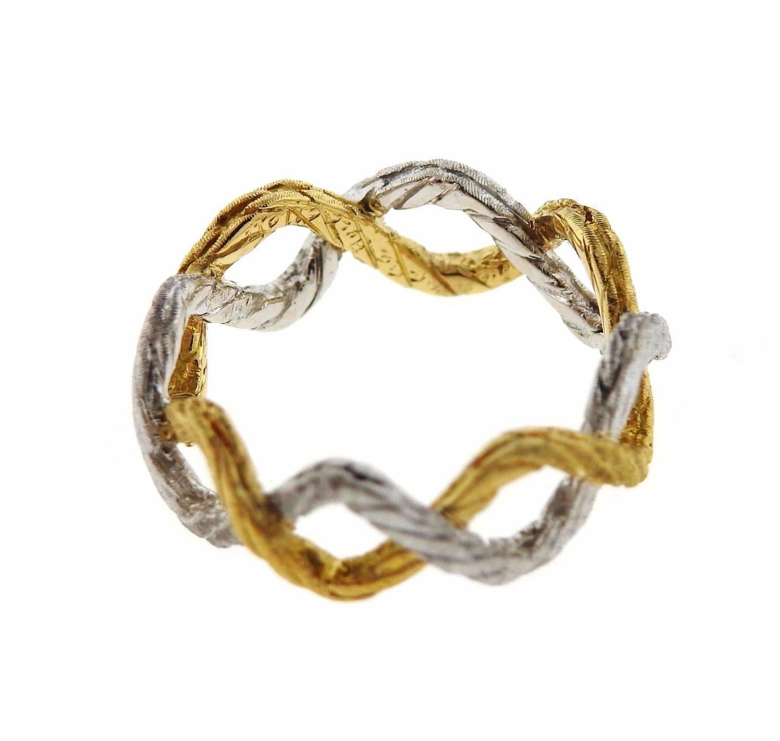 An 18k yellow and white gold braided band ring.  The ring is a size 5 1/2, ring is 7.5mm wide.  The weight of the piece is 3.8 grams.  Marked: Buccellati Italy 18k.  Retail is $1880. Comes with Buccellati paperwork.