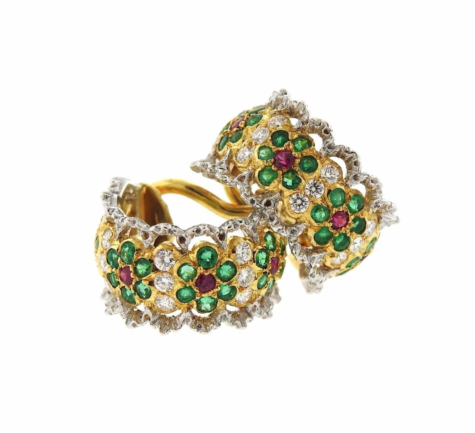 A pair of 18k yellow and white gold earrings set with emeralds, rubies, and approximately 0.25ctw of H/VS diamonds.  The earrings measure 15mm x 9mm wide and weigh 7.7 grams.  Marked: Buccellati Italy 18k.  Retail is $23,130. Come with Buccellati