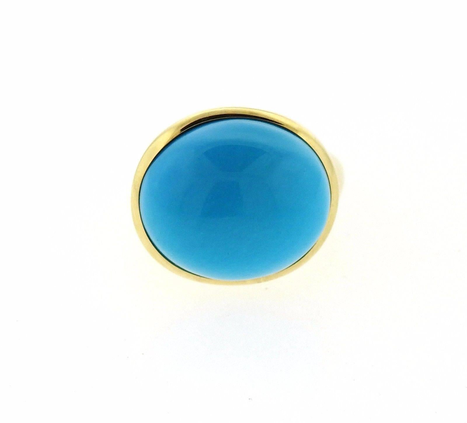 An 18k yellow gold ring set with a 19mm turquoise.  The ring is a size 7.  The ring top is 18mm x 21mm and sits approximately 16mm from the finger.  The weight of the piece is 19 grams.  Marked: Tiffany & Co, Elsa Peretti, 750, Hong Kong.  Comes