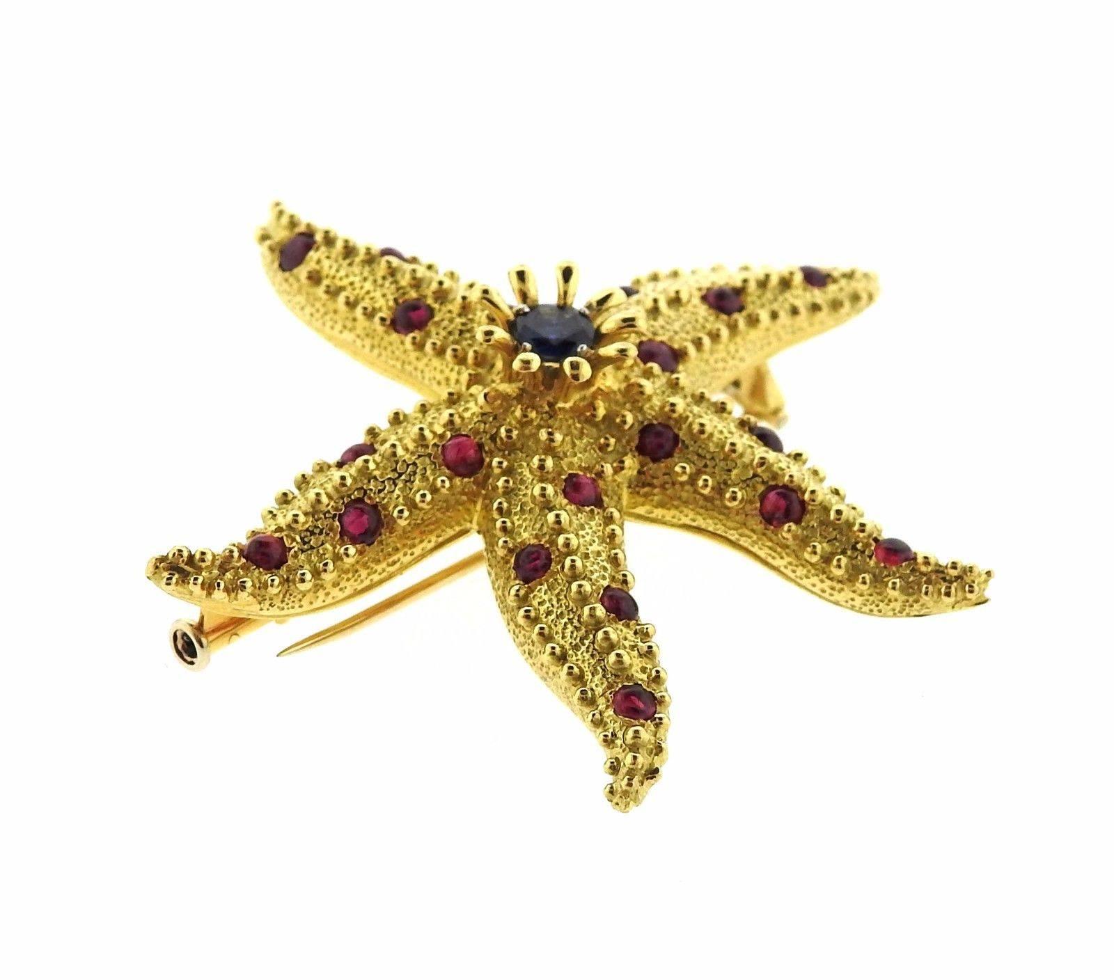 Une broche en or jaune 18k sertie de rubis et de saphirs.  La broche mesure 50mm x 50mm et pèse 20::9 grammes. Marqué : Tiffany & Co. 18k Schlumberger