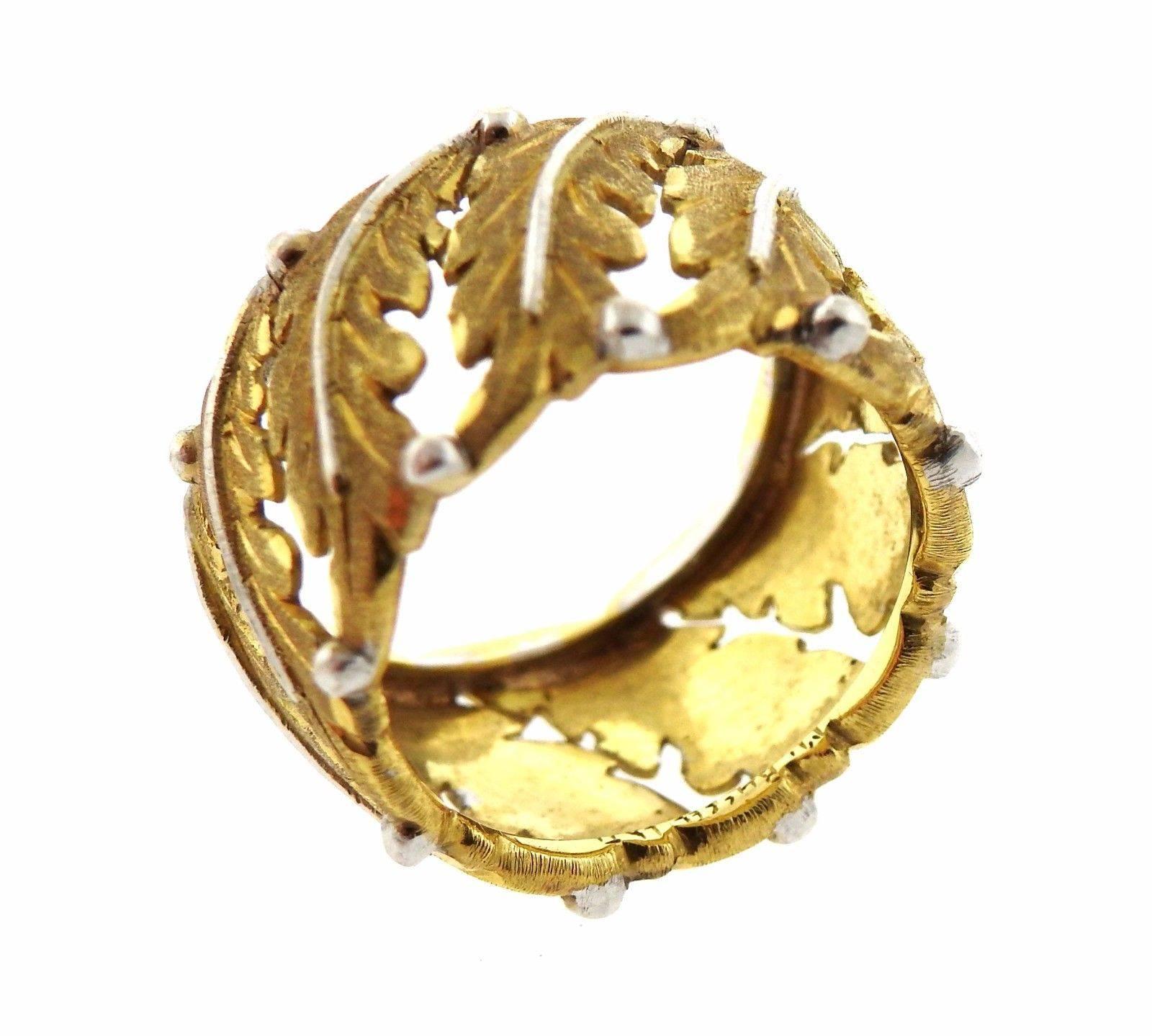 An 18k yellow and white gold ring by Buccellati.  The ring is a size 5.5 and measures 11.5mm wide.  The weight of the piece is 7.9 grams.  Marked Buccellati 750.