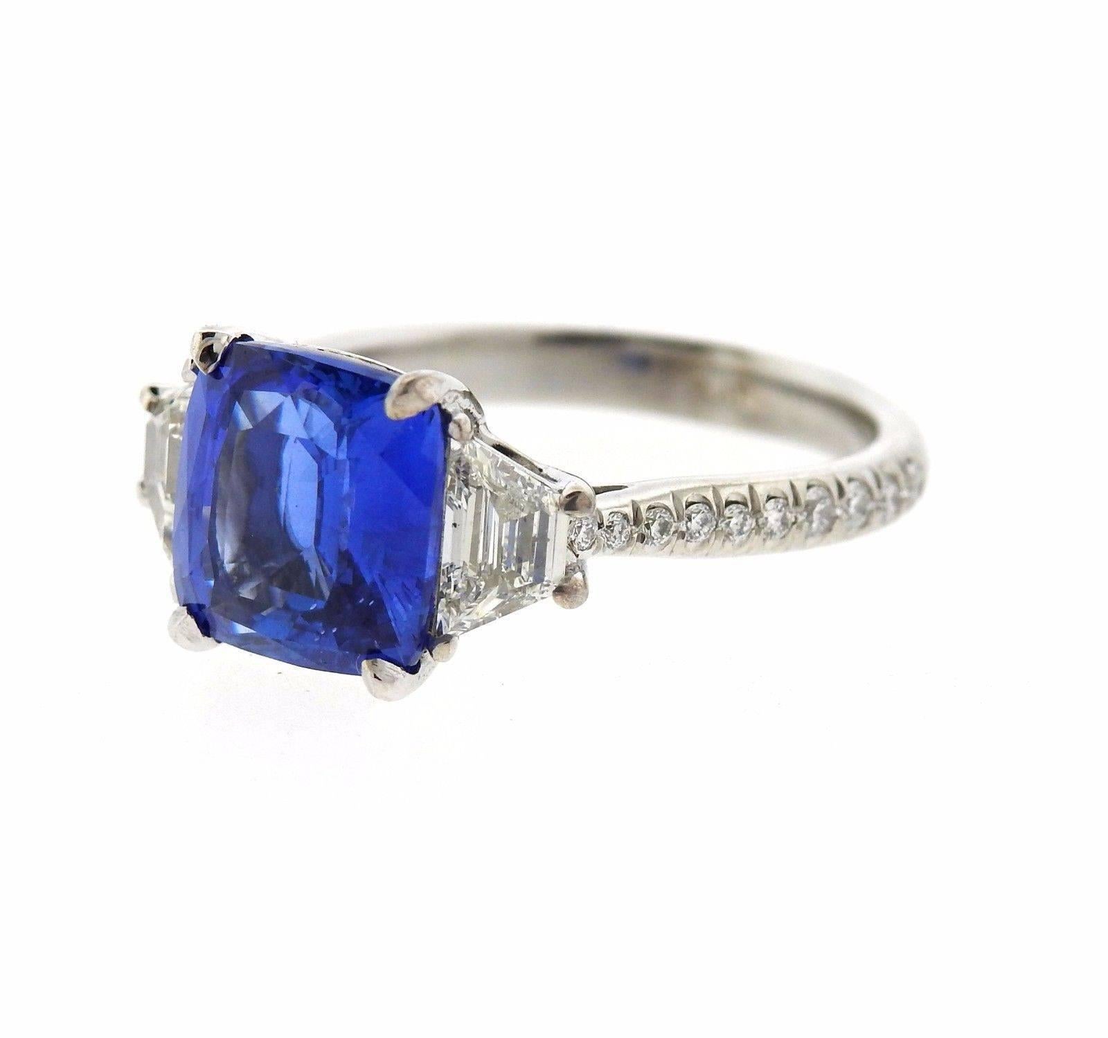 A platinum ring set with a 4.04ct natural sapphire and approximately 0.75ctw of G/VS diamonds.  The ring is a size 6, ring top is 9.2mm x 14.6mm.  The weight of the piece is 5.9 grams.